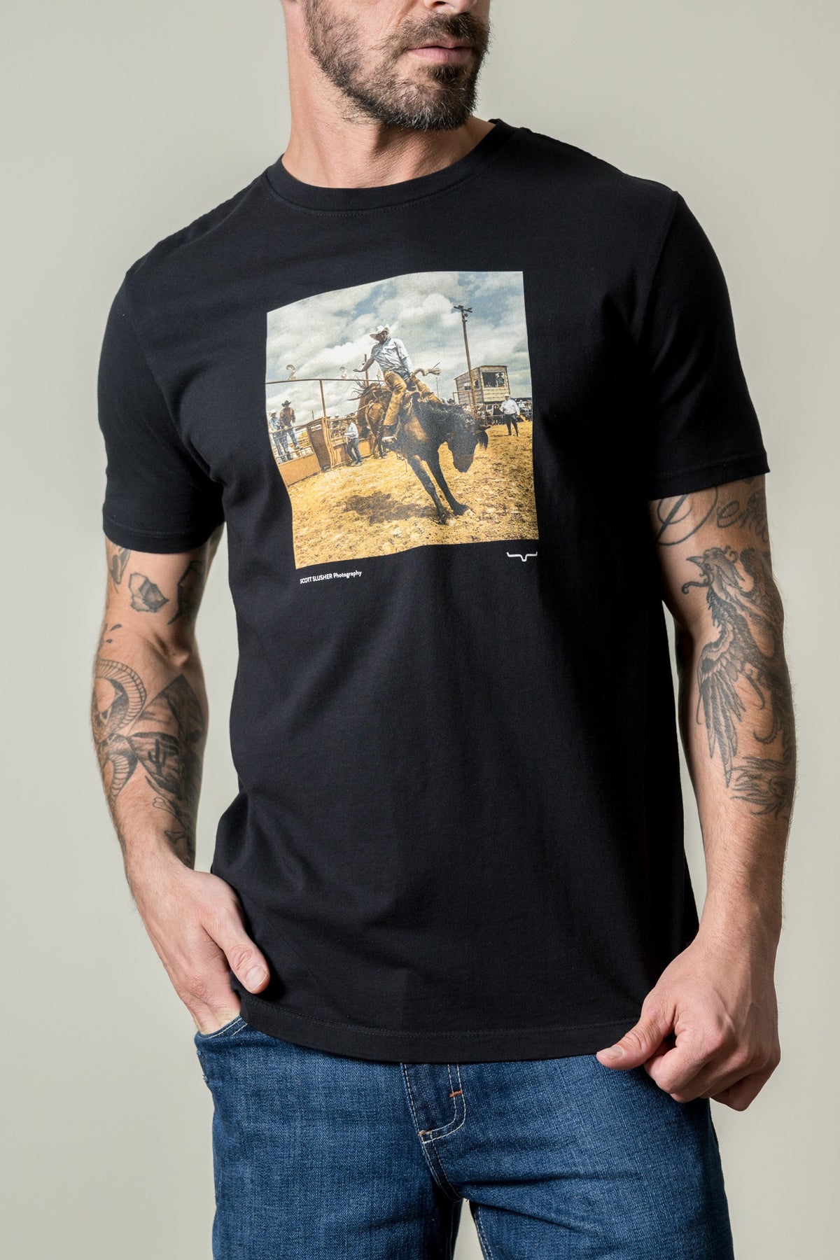 Kimes Ranch SS Classic Event black shirt with a photo print of a cowboy riding a bucking bronco