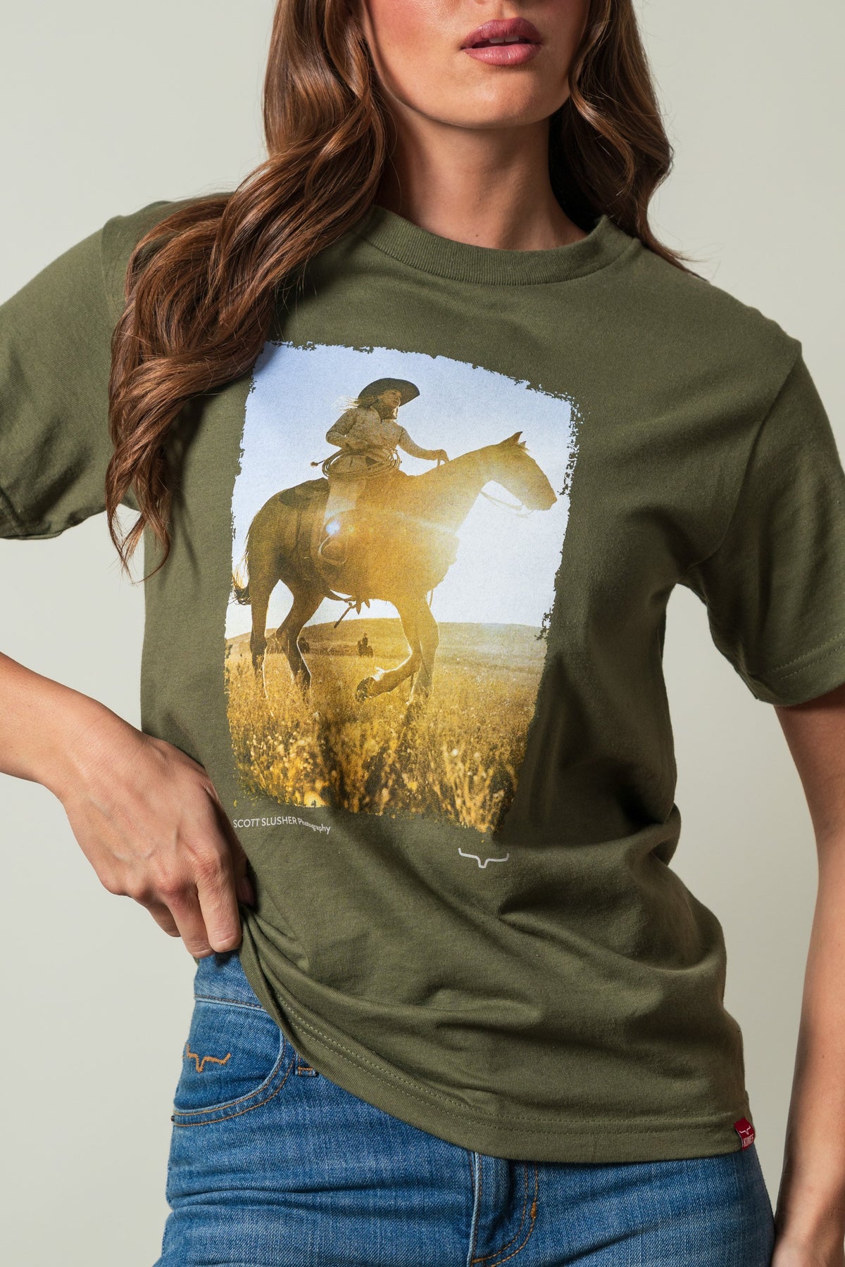 Kimes Ranch SS Riding Sunshine Military Green t-shirt with graphic of woman on horse, Scott Slusher Photography