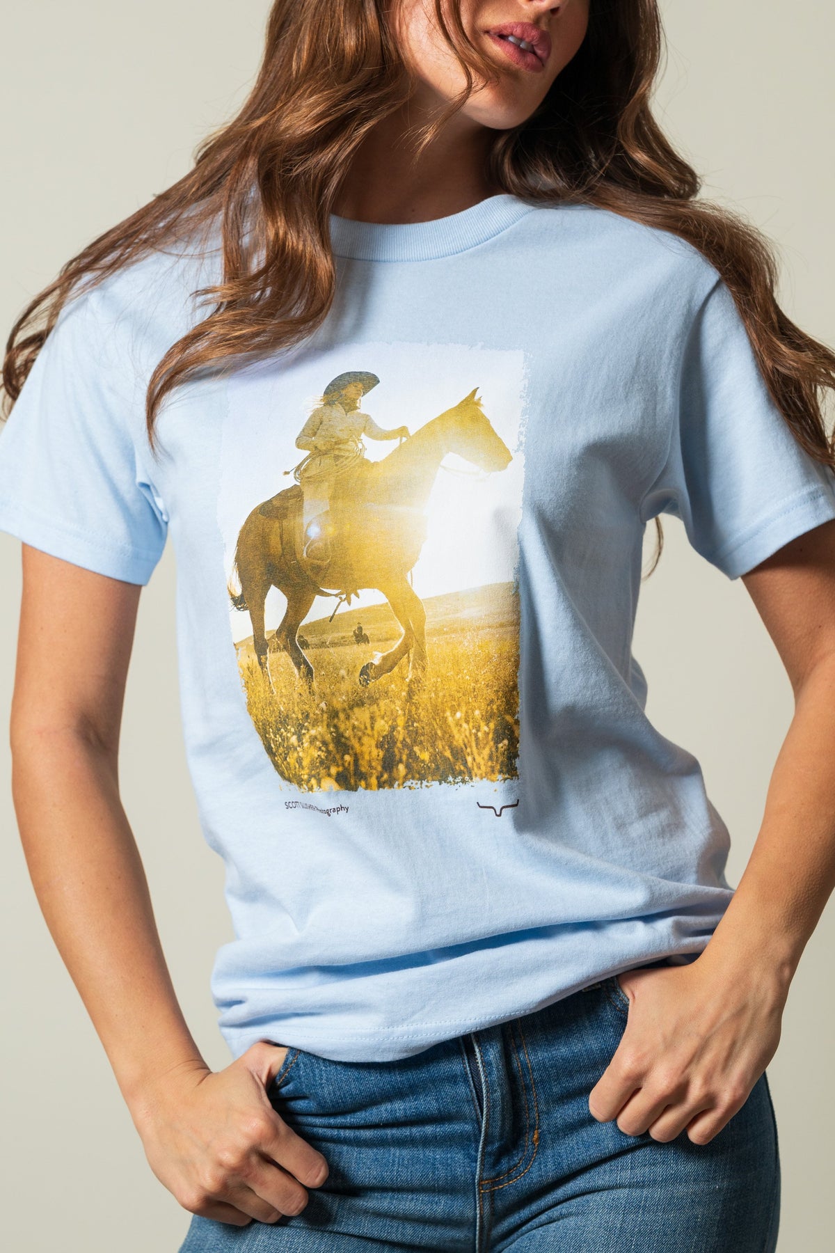 Kimes Ranch SS Riding Sunshine t-shirt, powder blue, with short sleeves, featuring a graphic print of a rider on horseback