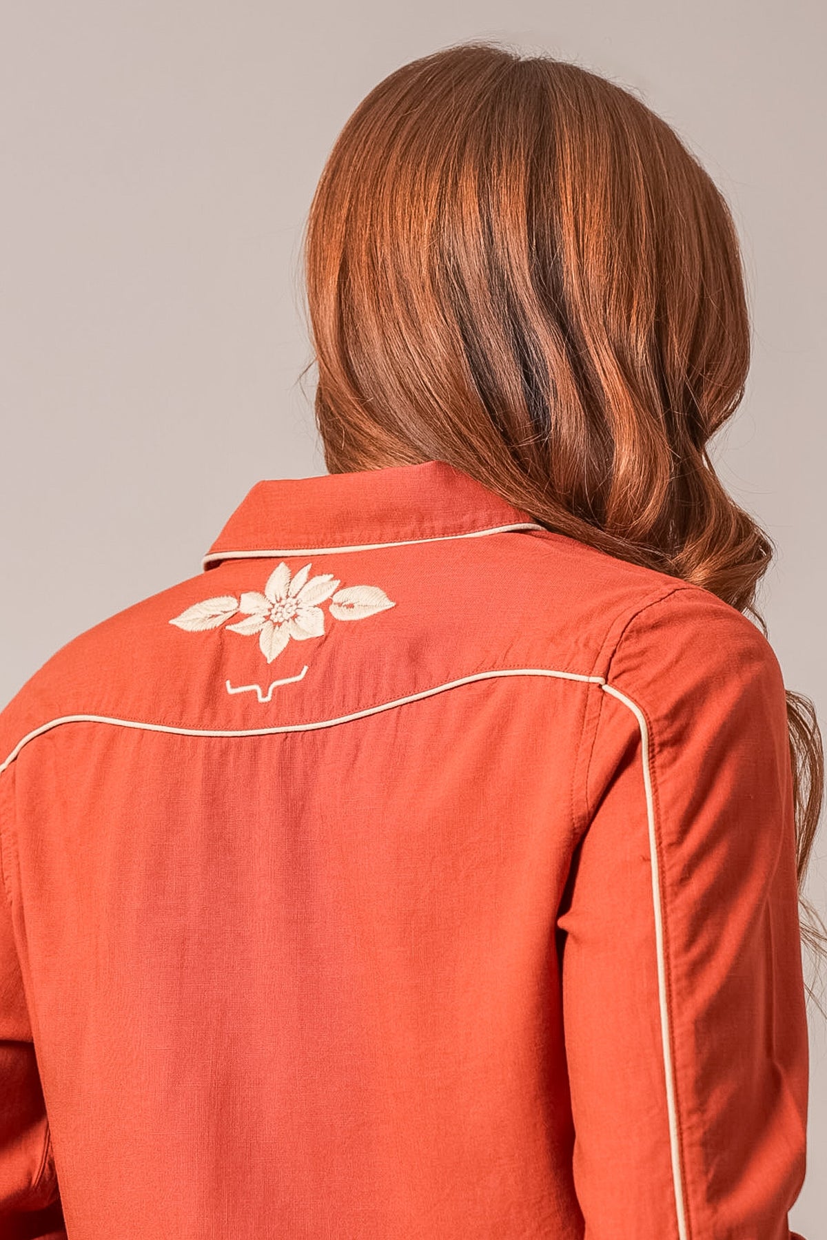Kimes Ranch Stevie Top in Burnt Red with white floral embroidery on the back yoke