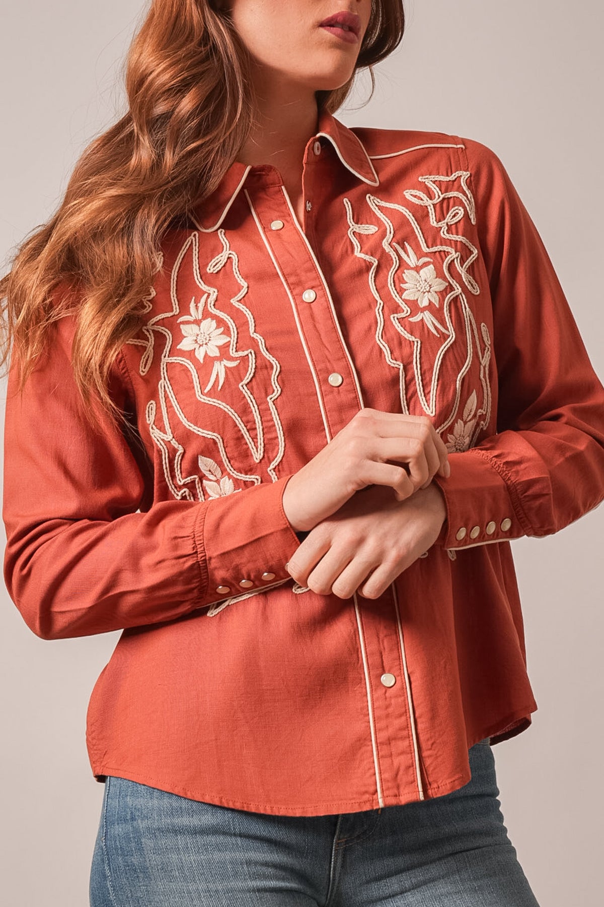 Kimes Ranch Stevie long sleeve embroidered top in Burnt Red with white floral design and contrast stitching