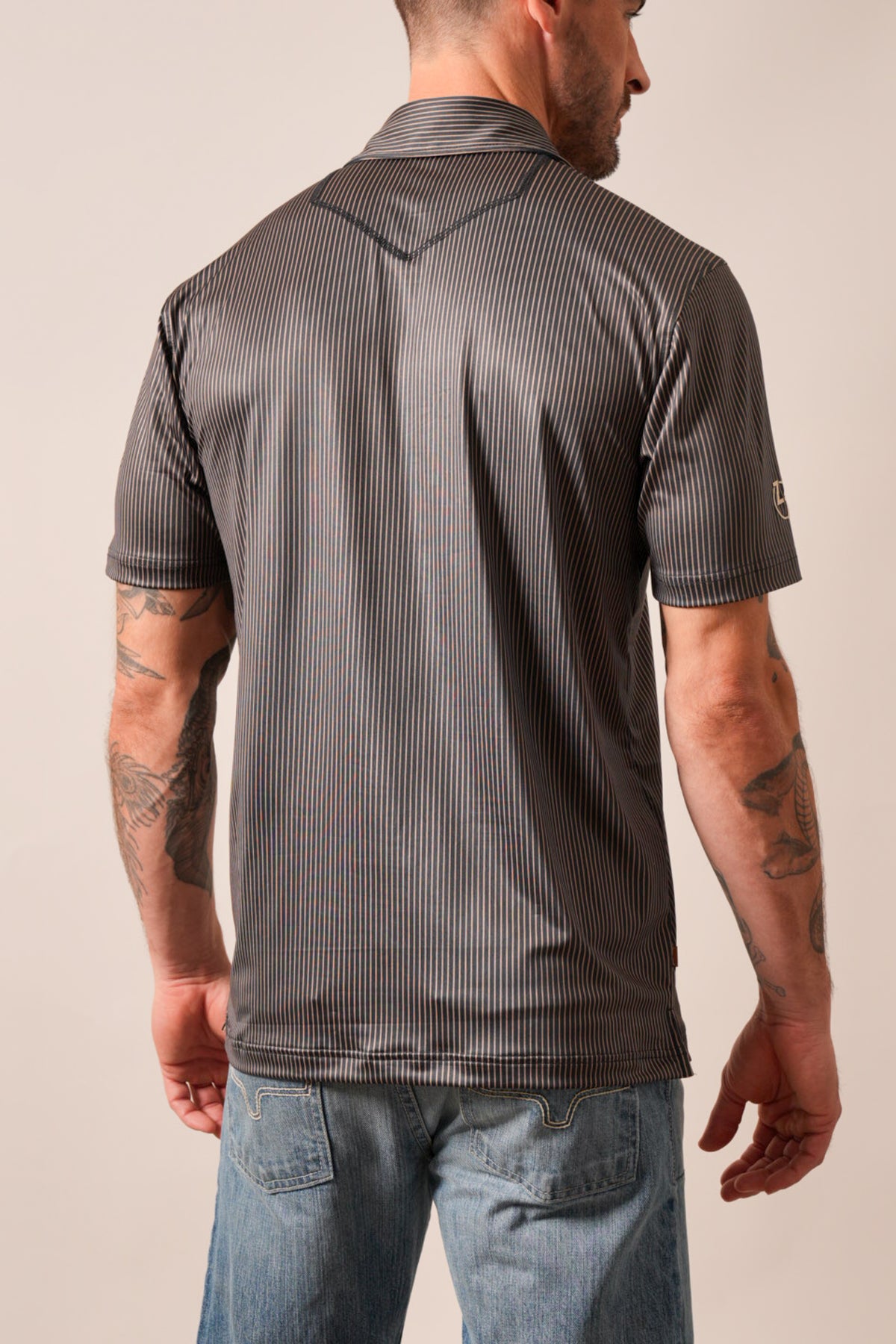 Kimes Ranch ZT Loomis men's black polo with short sleeves, striped pattern, V-yoke back, and logo on left sleeve