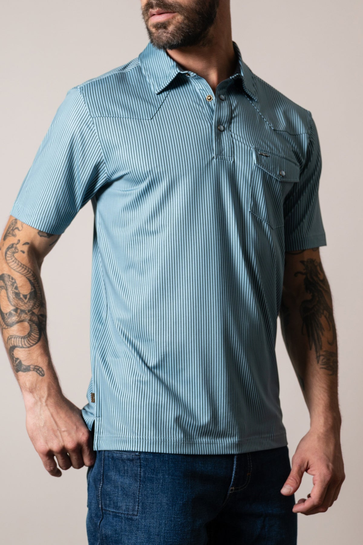 Kimes Ranch ZT Loomis polo shirt in light blue, short-sleeved with vertical stripes, chest pocket, and collar