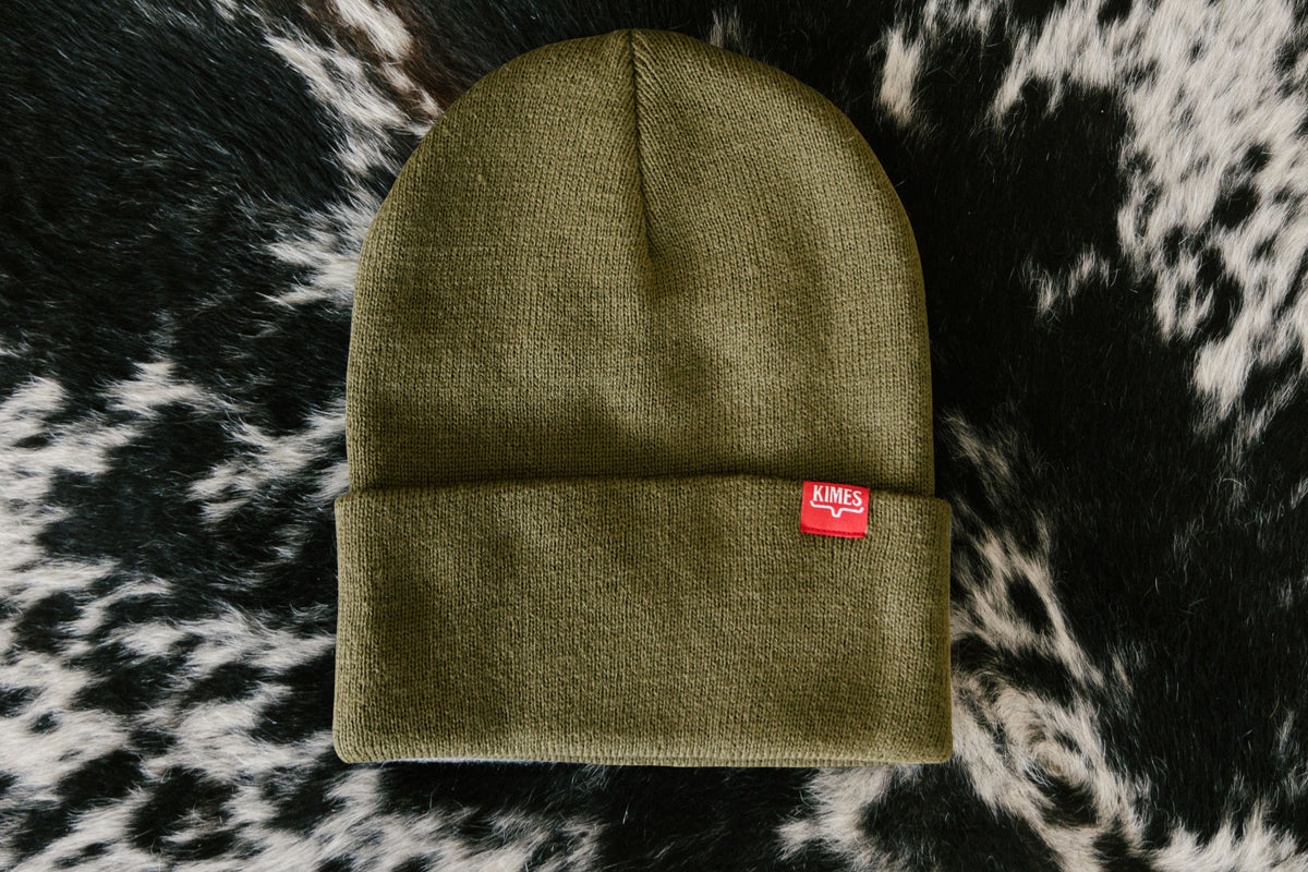 Kimes Ranch KR Clipped Hat in Olive with a red woven logo patch on the folded cuff