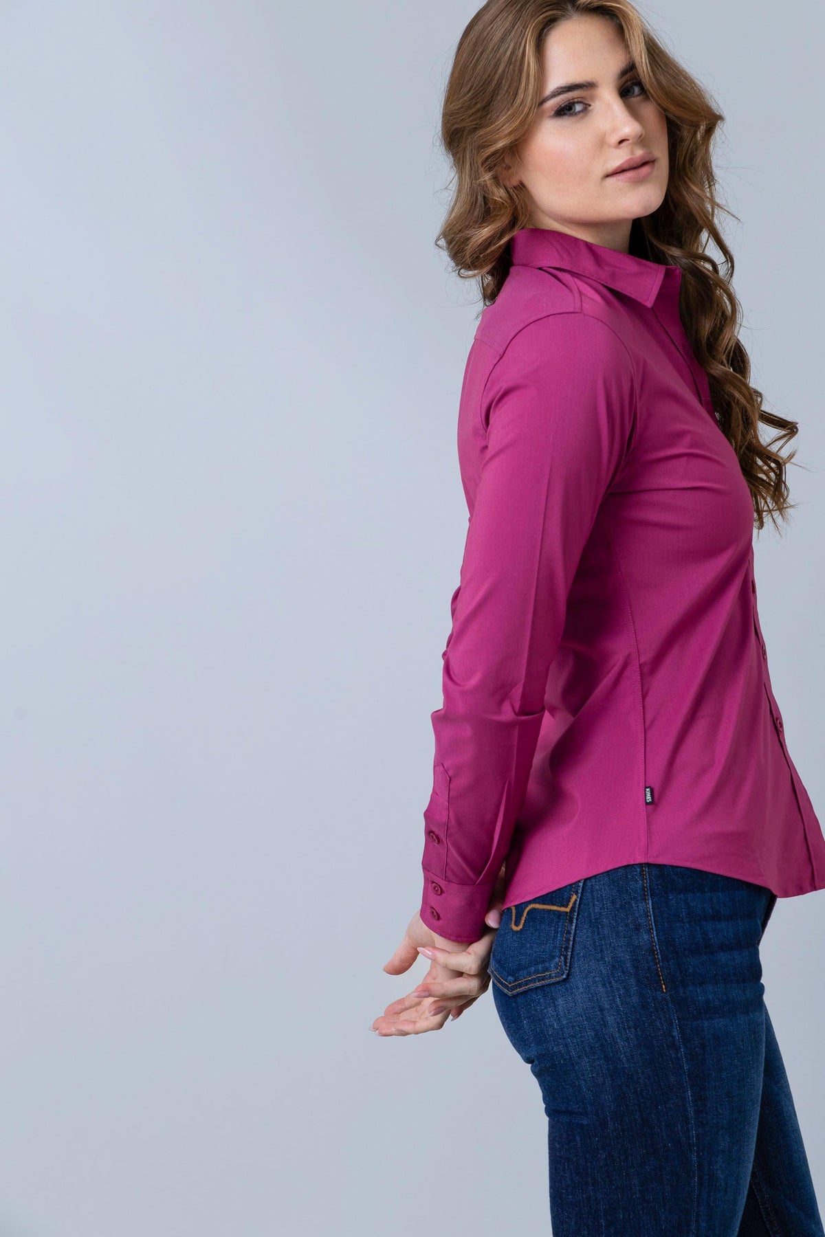 Kimes Ranch Ladies Linville top in Magenta, side view, with long sleeves and a tailored fit