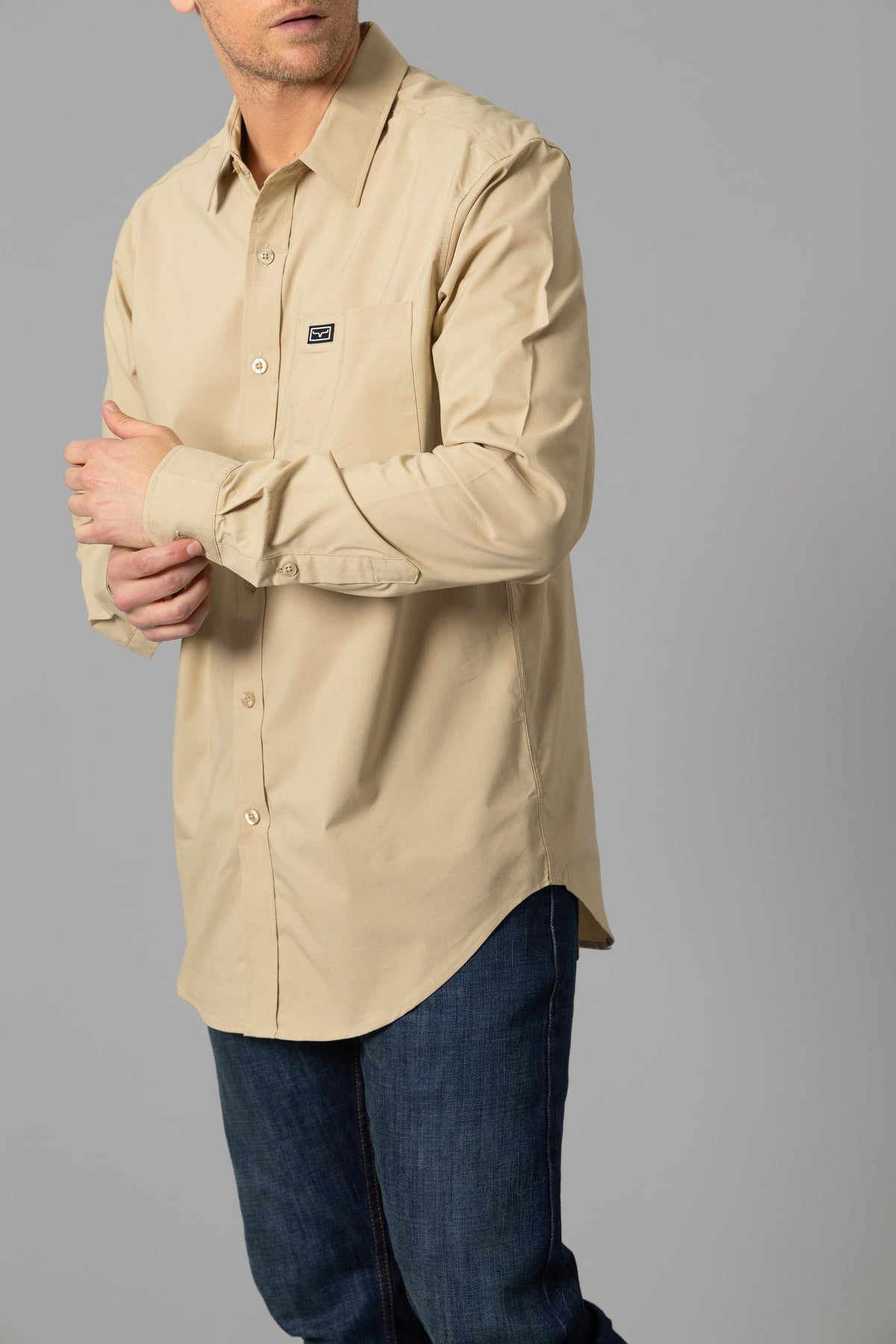 Kimes Ranch Linville Long Sleeve Dress Shirt in Khaki, side view, with a chest pocket and logo patch