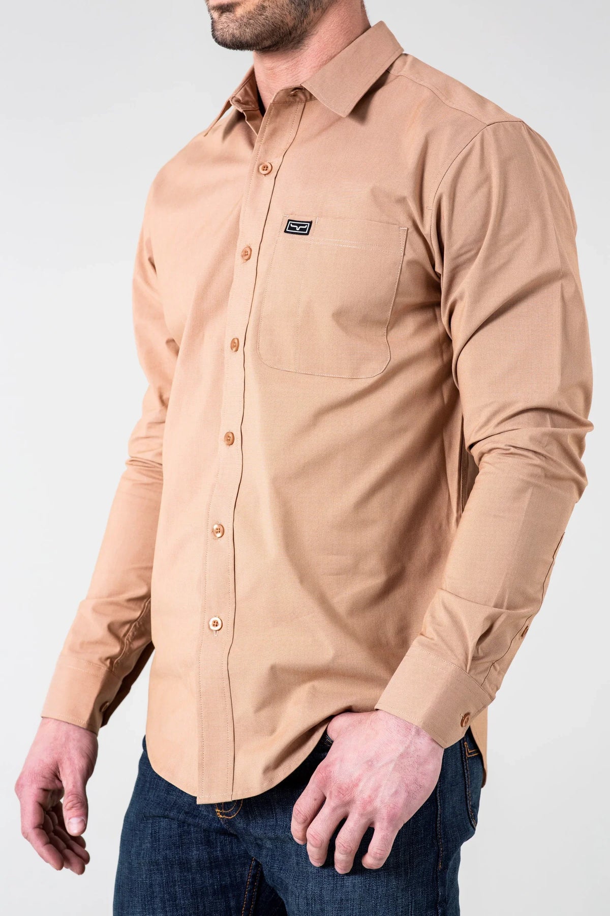 Kimes Ranch Linville Long Sleeve Dress Shirt in Desert Brown, side view, with a chest pocket and logo patch