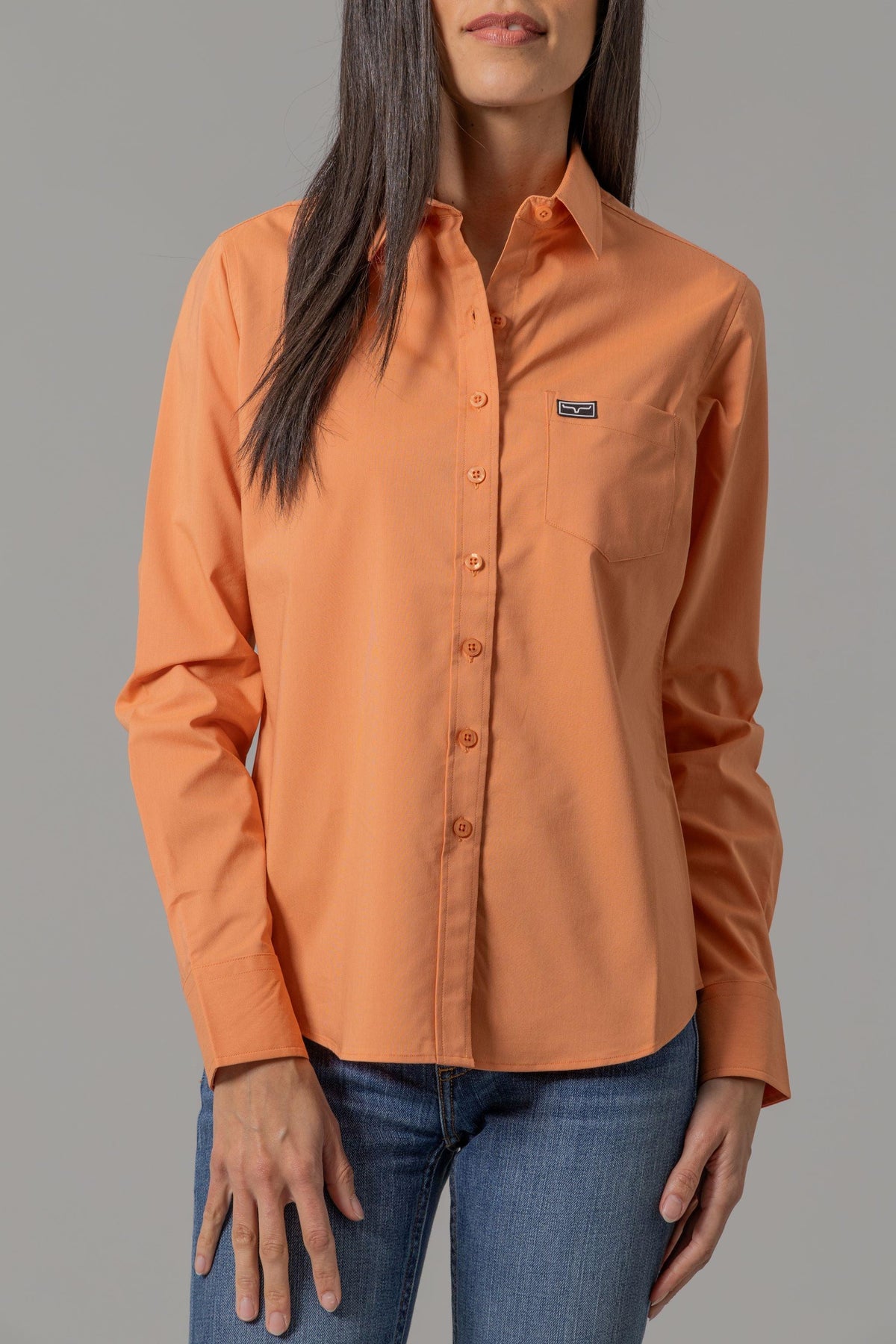 Kimes Ranch Ladies Linville long sleeve button-up top in Melon with a chest pocket and logo patch