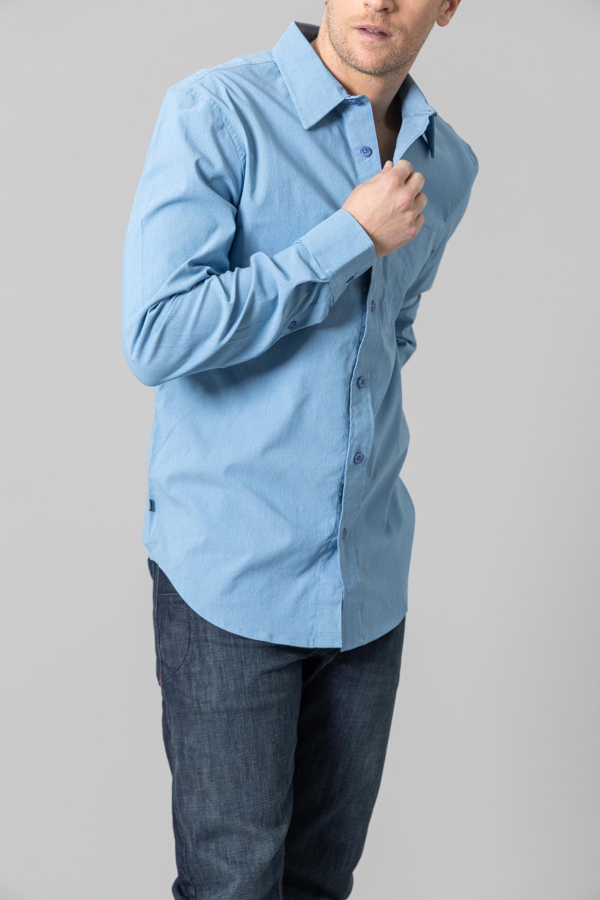 Kimes Ranch Linville Long Sleeve Dress Shirt in Mid Blue, side view, with a button front and collar