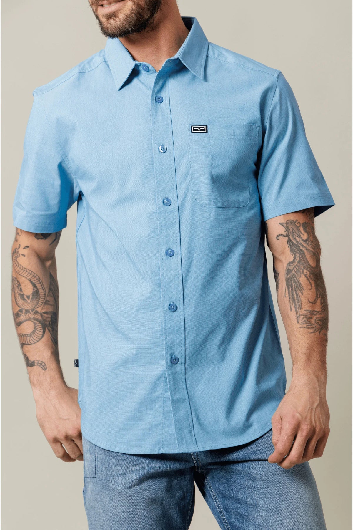Kimes Ranch Linville Short Sleeve Dress Shirt in Mid Blue with a chest pocket and logo