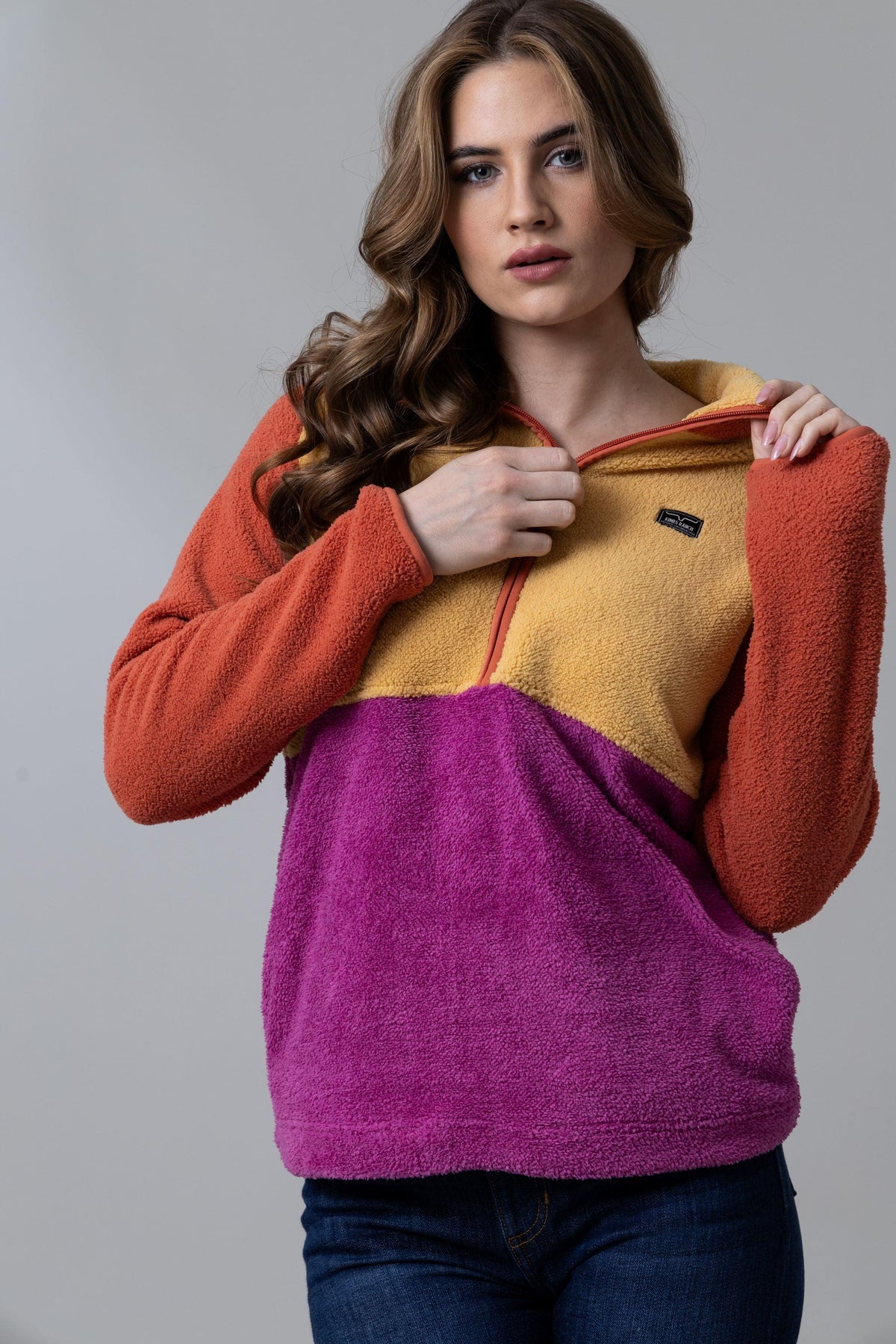 Kimes Ranch Roswell Polar Fleece sweatshirt in Burnt Orange with mustard and purple color blocking and a half-zip front