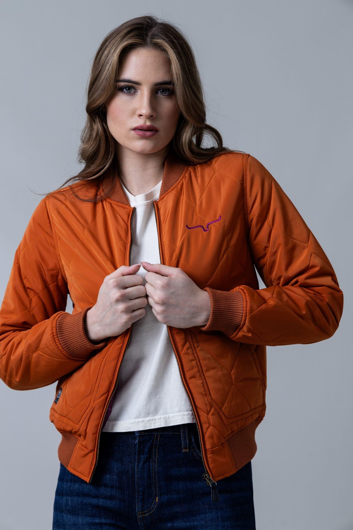 Kimes Ranch Marino Bomber Jacket in Burnt Orange with diamond quilting and embroidered logo