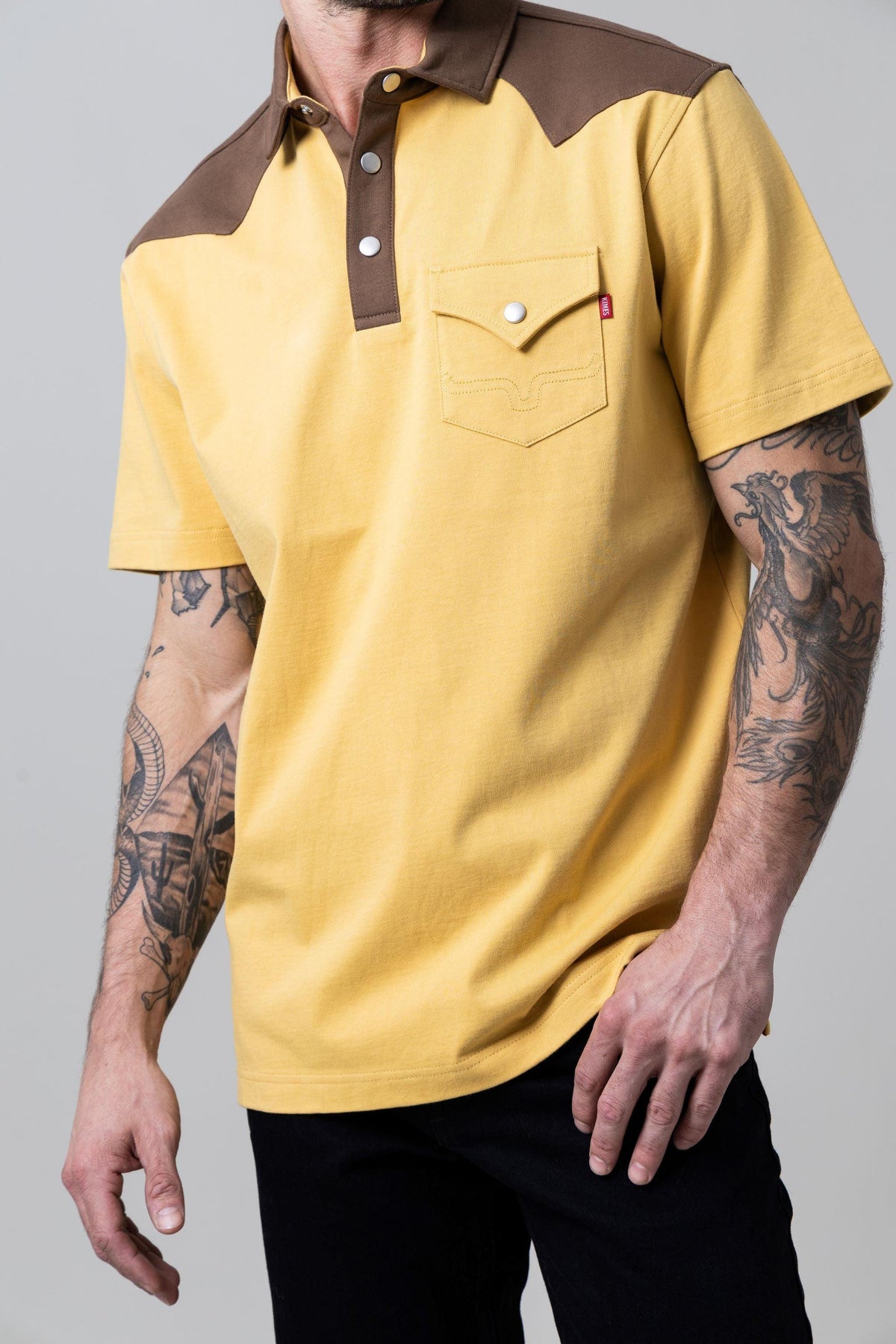 Kimes Ranch Gallup Polo in Maize with brown yoke and collar and a chest pocket with a red tag