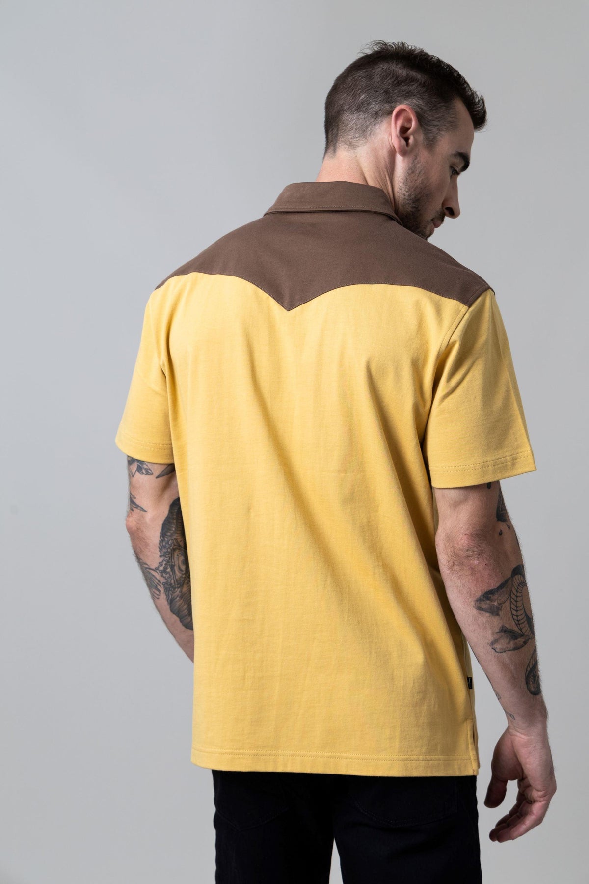 Kimes Ranch Gallup Polo in Maize, back view, with brown back yoke and collar
