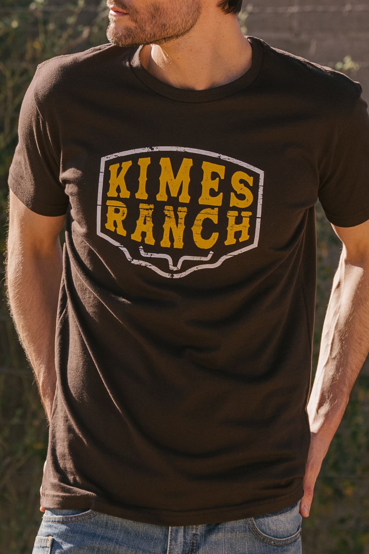 Kimes Ranch Wood Block shirt in Dark Chocolate with a distressed yellow and white Kimes Ranch logo on the chest
