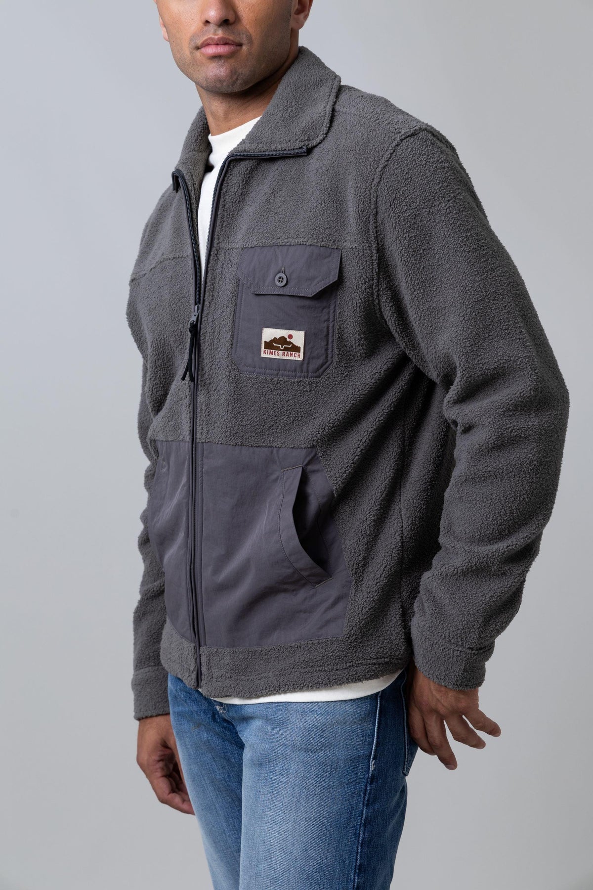 Kimes Ranch Maxwell, side view, Grey Heather sweatshirt with a buttoned chest pocket and a logo patch