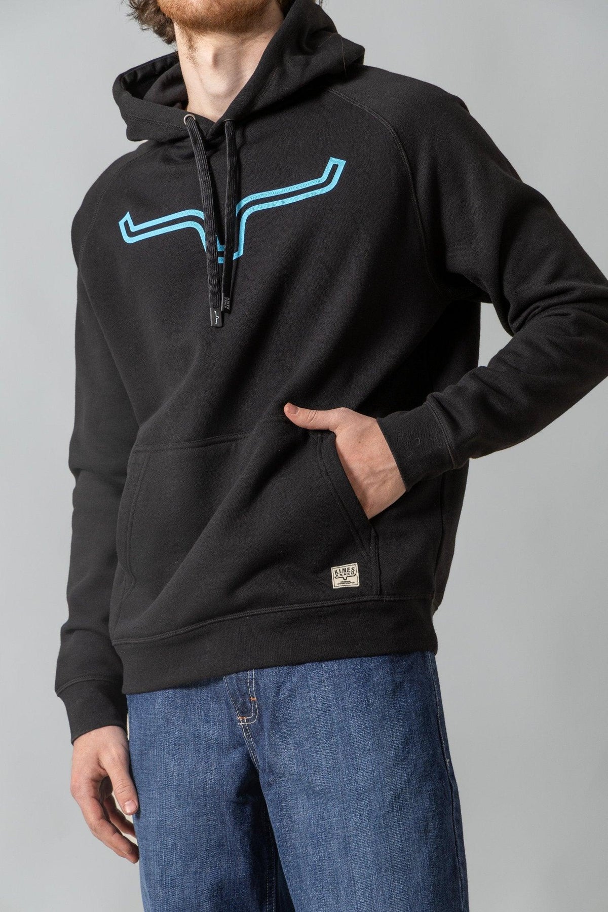 Kimes Ranch Outlier Hoodie in Black with a light blue graphic on the chest and a front kangaroo pocket