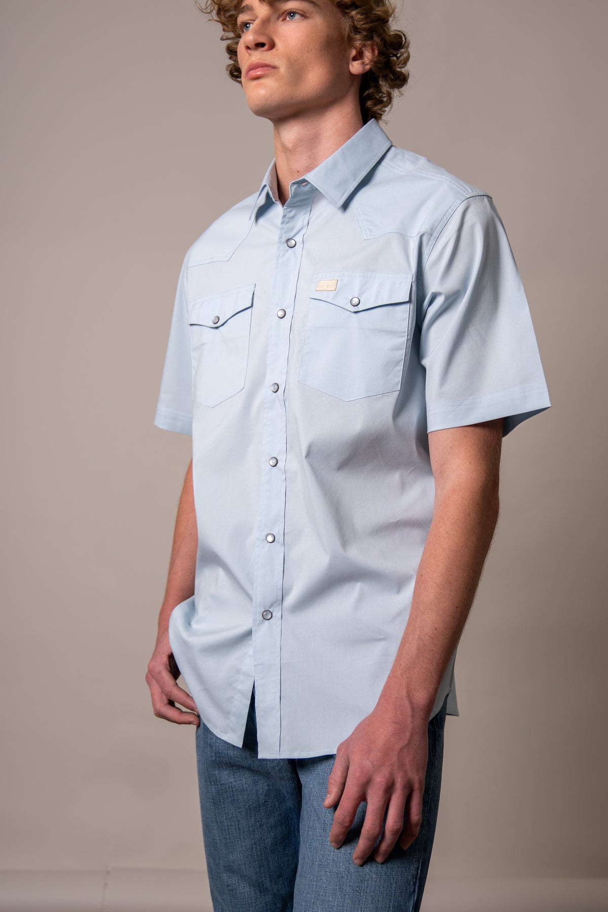 Kimes Ranch Rio Short Sleeve Dress Shirt in Light Blue, side view, with chest pockets and a collar