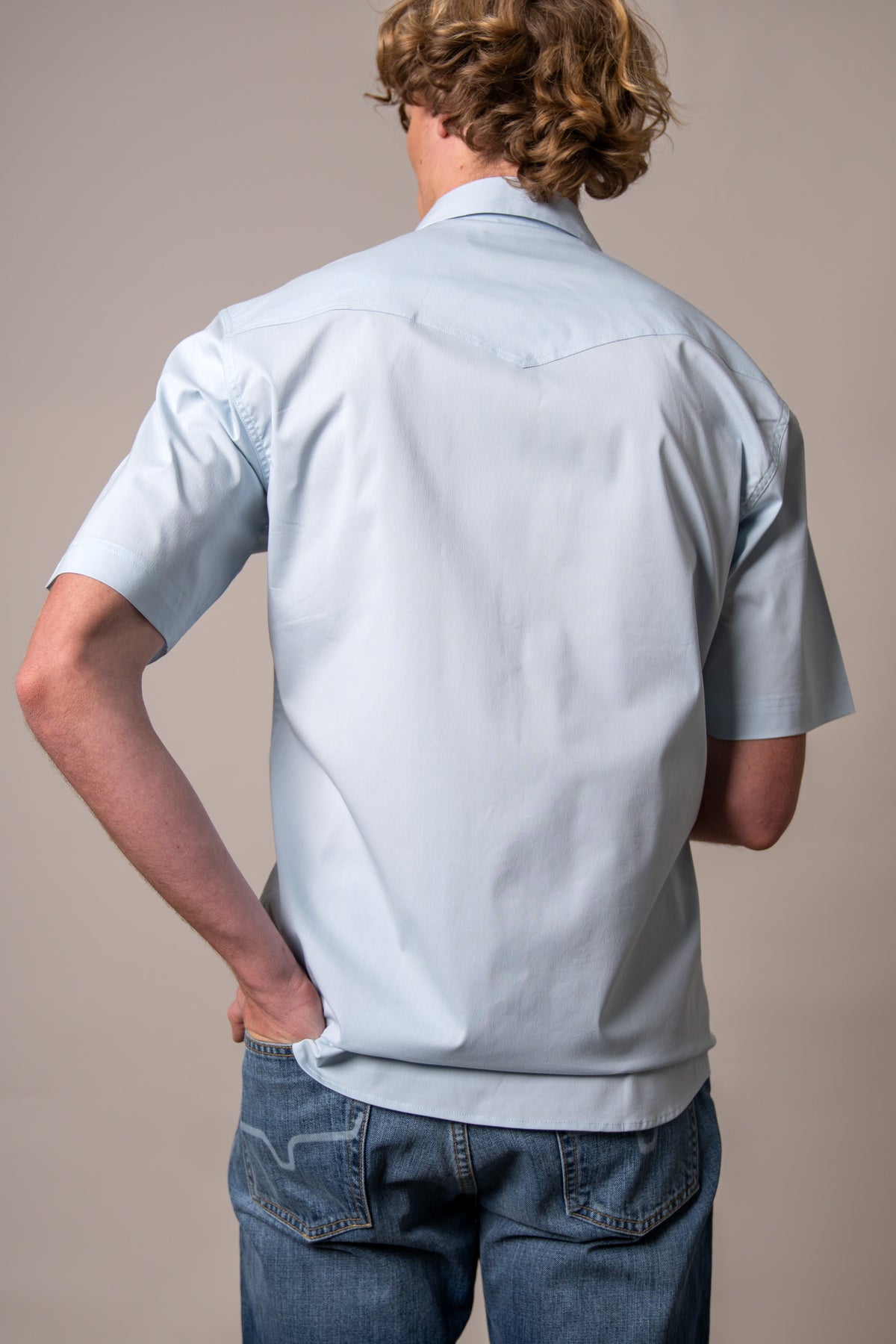 Kimes Ranch Rio Short Sleeve Dress Shirt in Light Blue, back view, with a back yoke and short sleeves