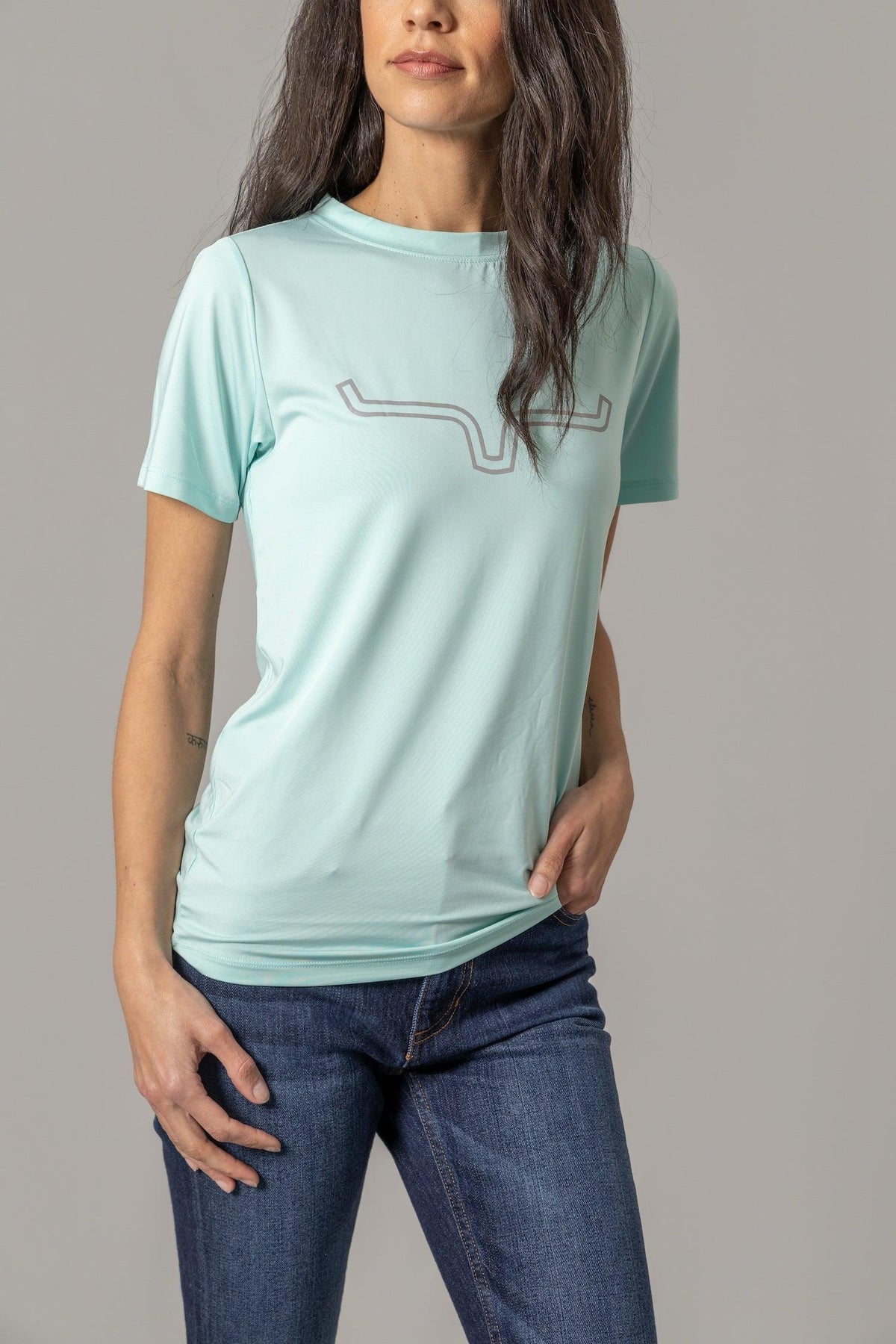 Kimes Ranch Ladies Outlier Tech Tee Shirt in Aqua with a longhorn logo graphic on the front