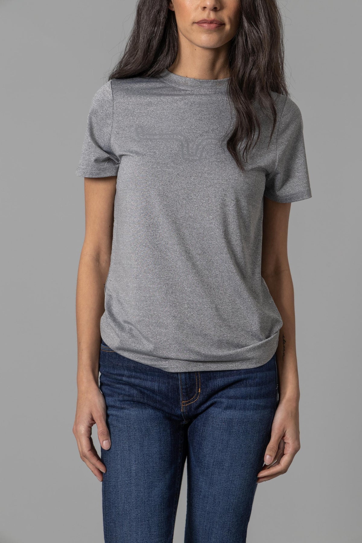 Kimes Ranch Ladies Outlier Tech Tee Shirt in Charcoal Heather with a tonal graphic on the chest