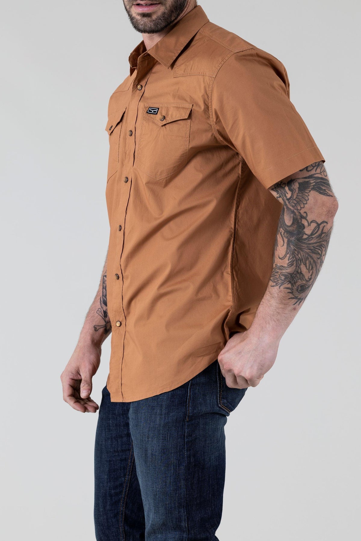 Kimes Ranch Rio Short Sleeve Dress Shirt in Work Wear Brown, side view, with chest pockets and a logo patch