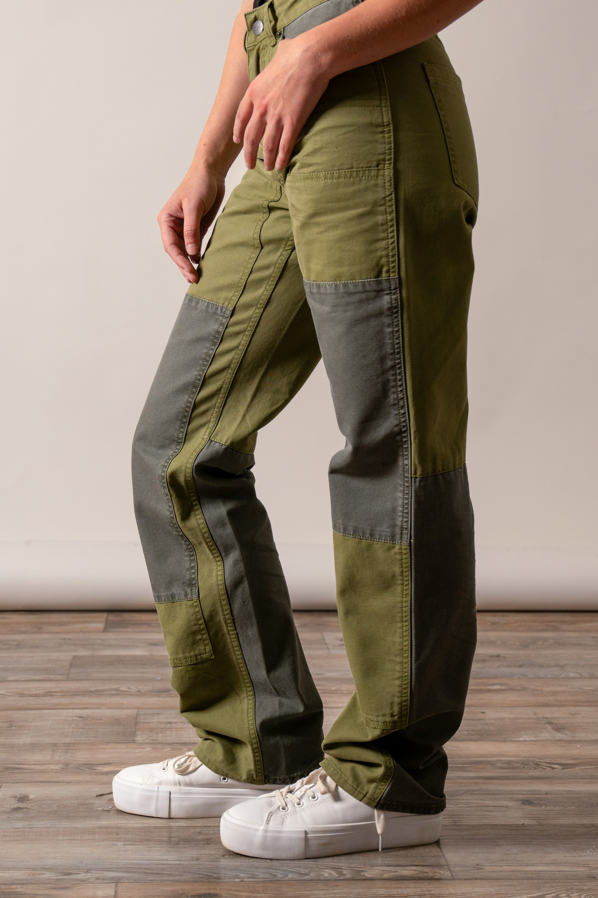 Kimes Ranch Sadona pants in Moss, side view, with grey paneling and patchwork details