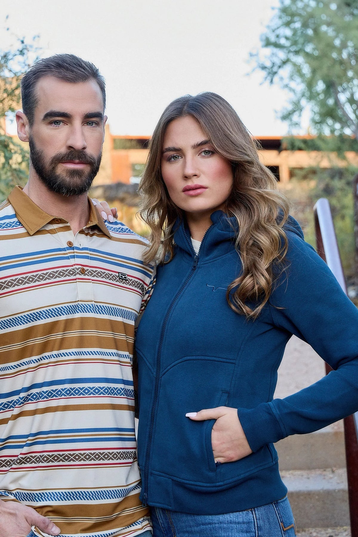 Kimes Ranch Mackin Stripe Polo in Natural with horizontal blue and brown stripes and a tan collar