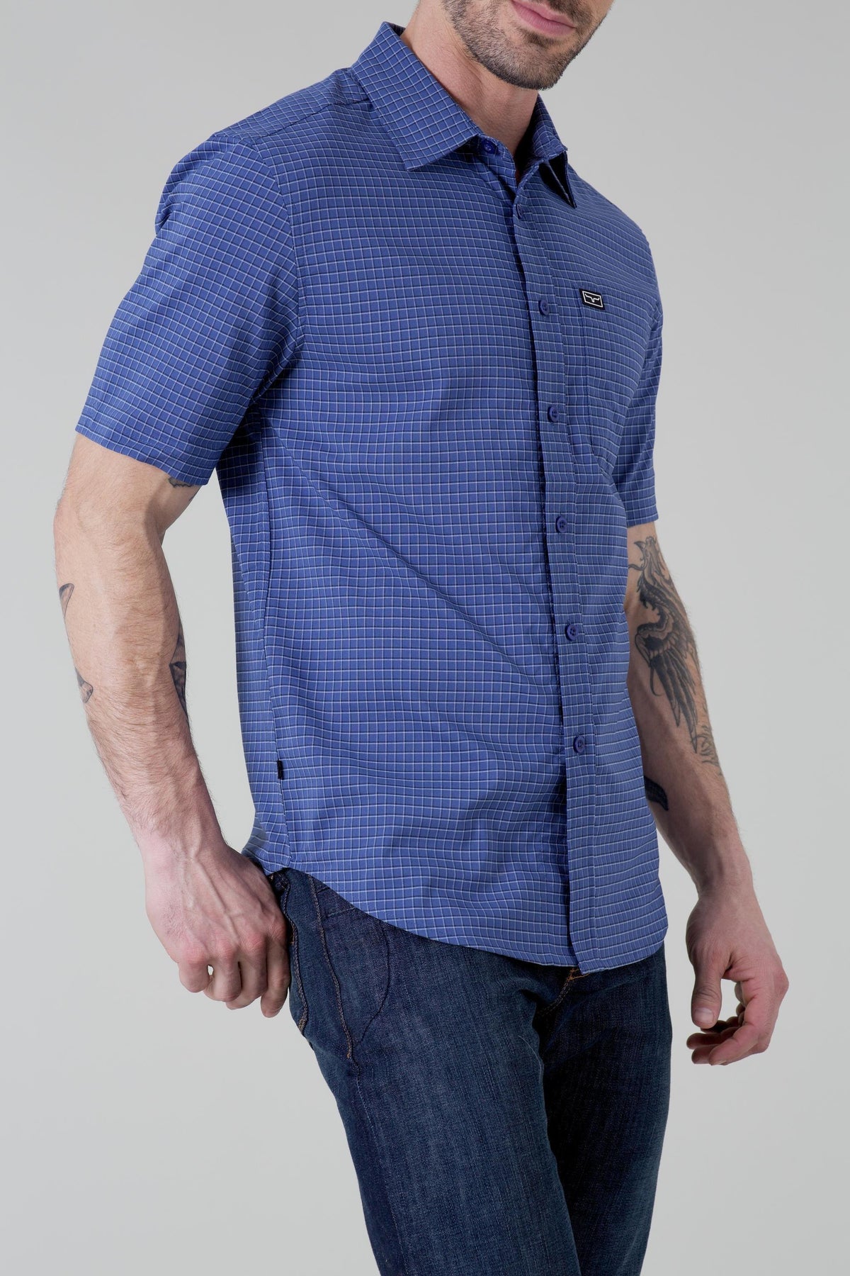 Kimes Ranch Spyglass Short Sleeve Dress Shirt in Blue, side view, with a grid pattern and a chest pocket