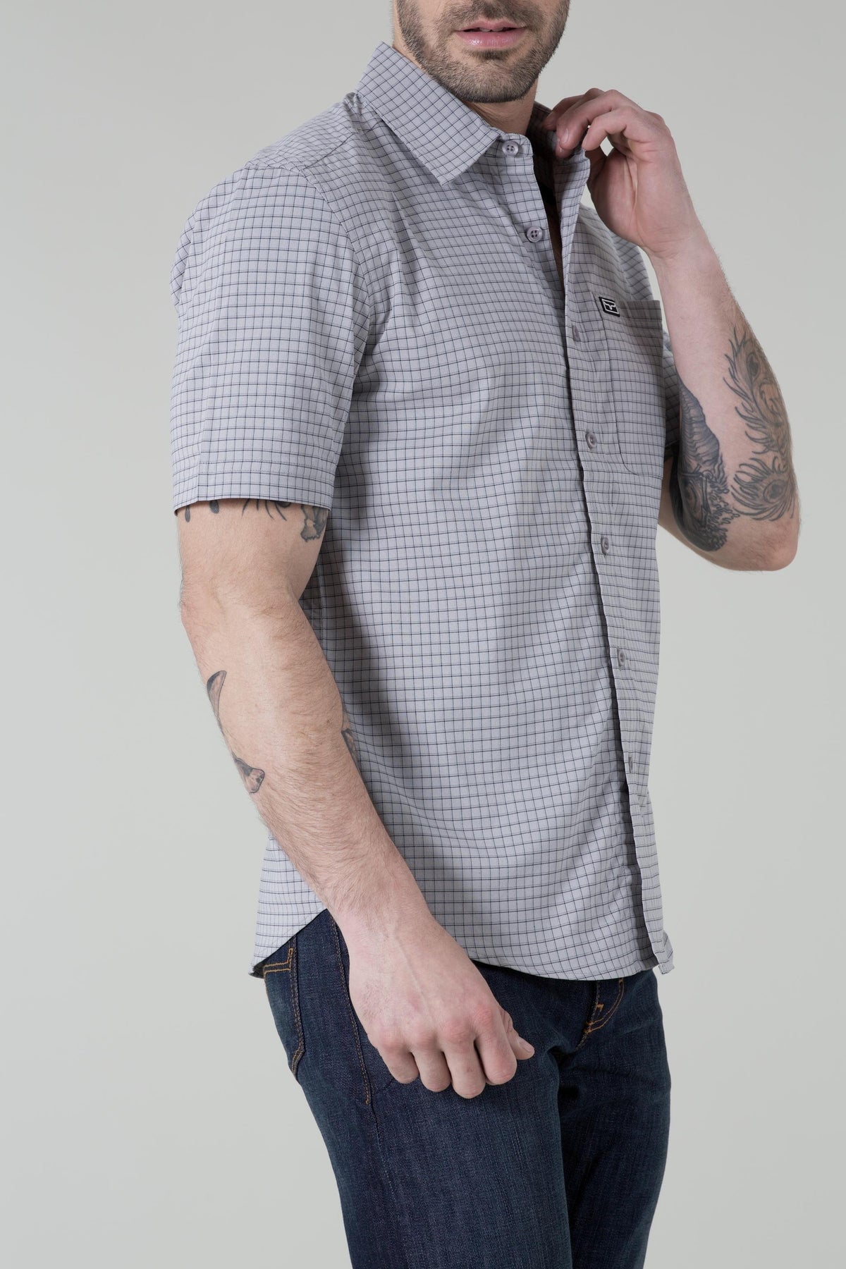Kimes Ranch Spyglass Short Sleeve Dress Shirt in Grey, side view, with a windowpane check pattern and a chest pocket