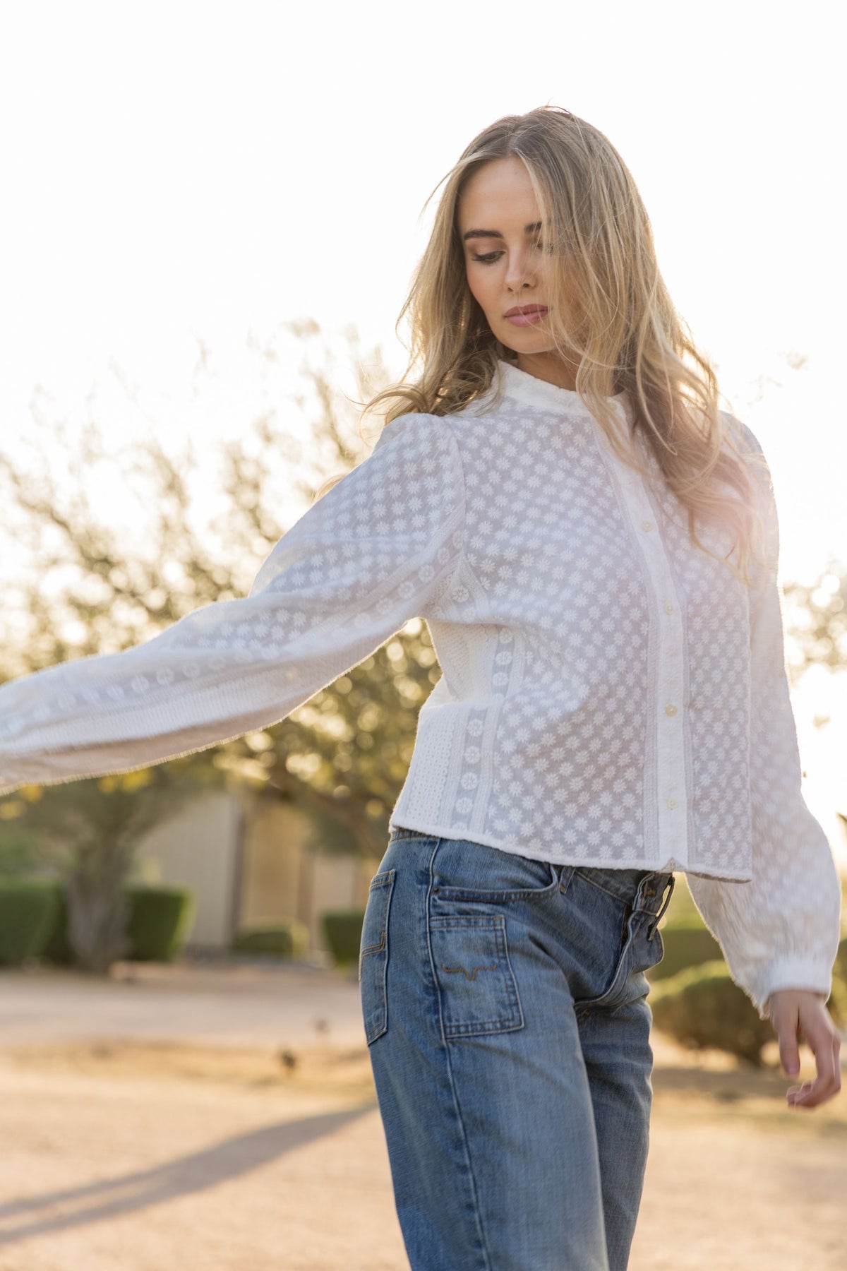 Kimes Ranch Daisychain top in Pristine, side view, with daisy eyelet pattern and long sleeves