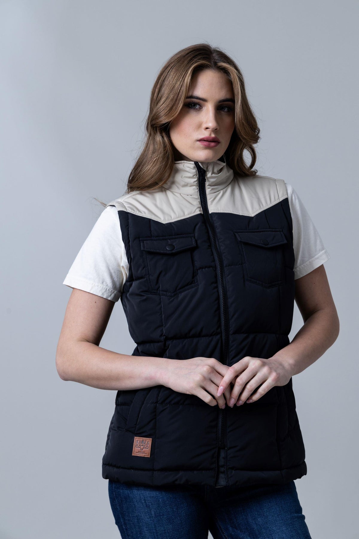Kimes Ranch Wyldfire Vest in Black with a cream yoke, front zip, two flap pockets, and a logo patch