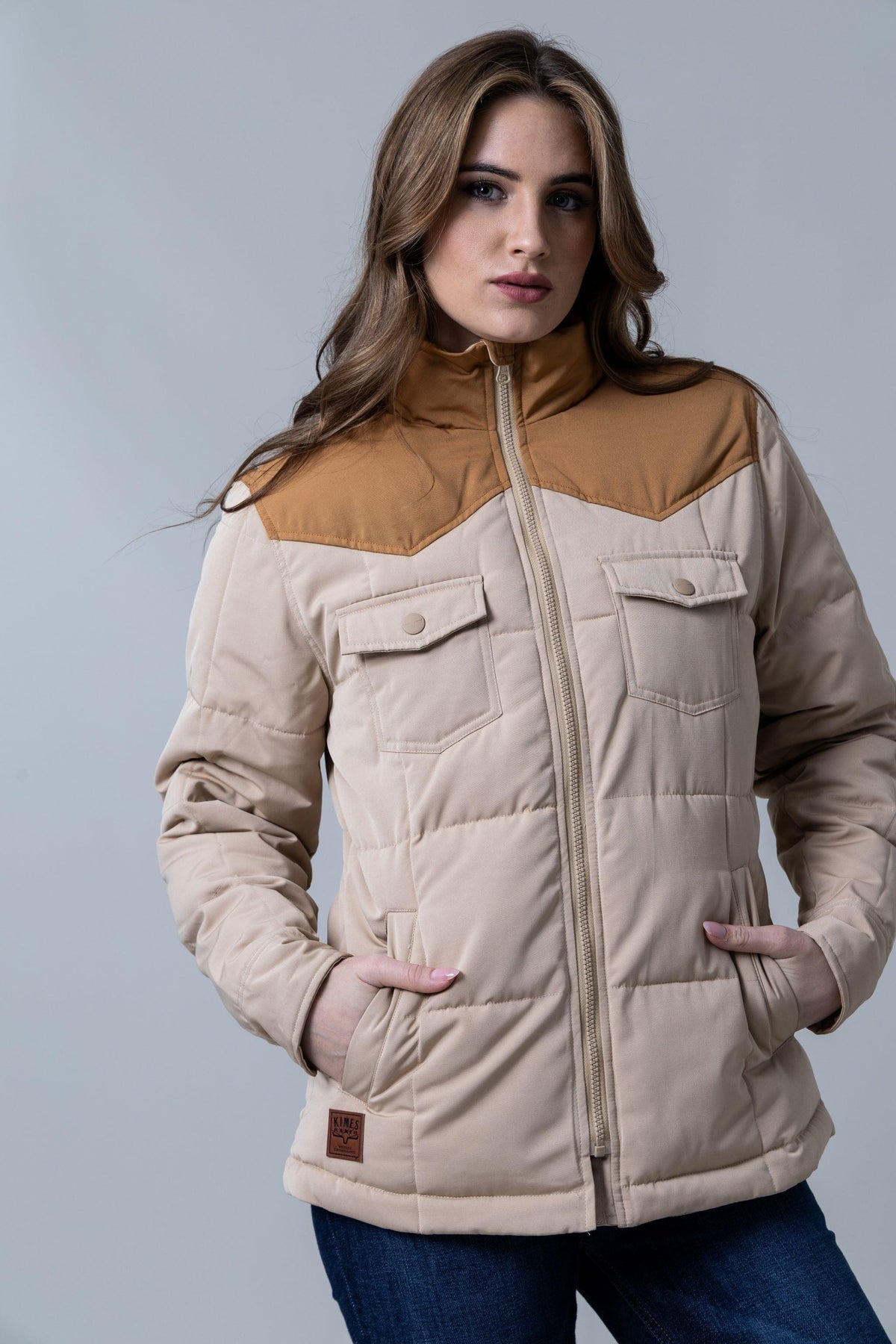 Kimes Ranch Wyldfire Jacket in Tan with a quilted body, snap flap pockets, and a contrasting yoke