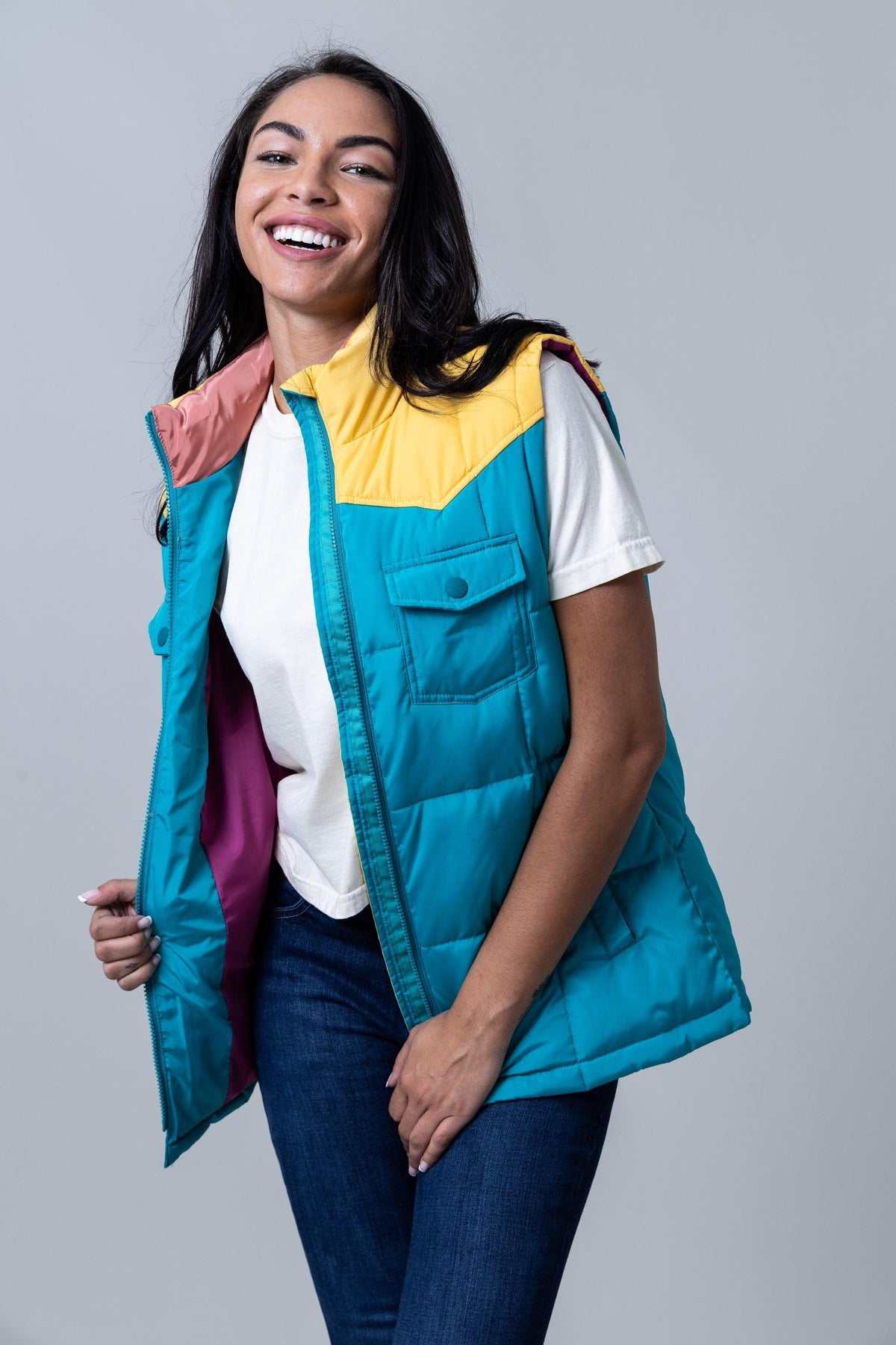 Kimes Ranch Wyldfire Vest in Teal with yellow yoke and pink lining, featuring a front pocket and zip closure