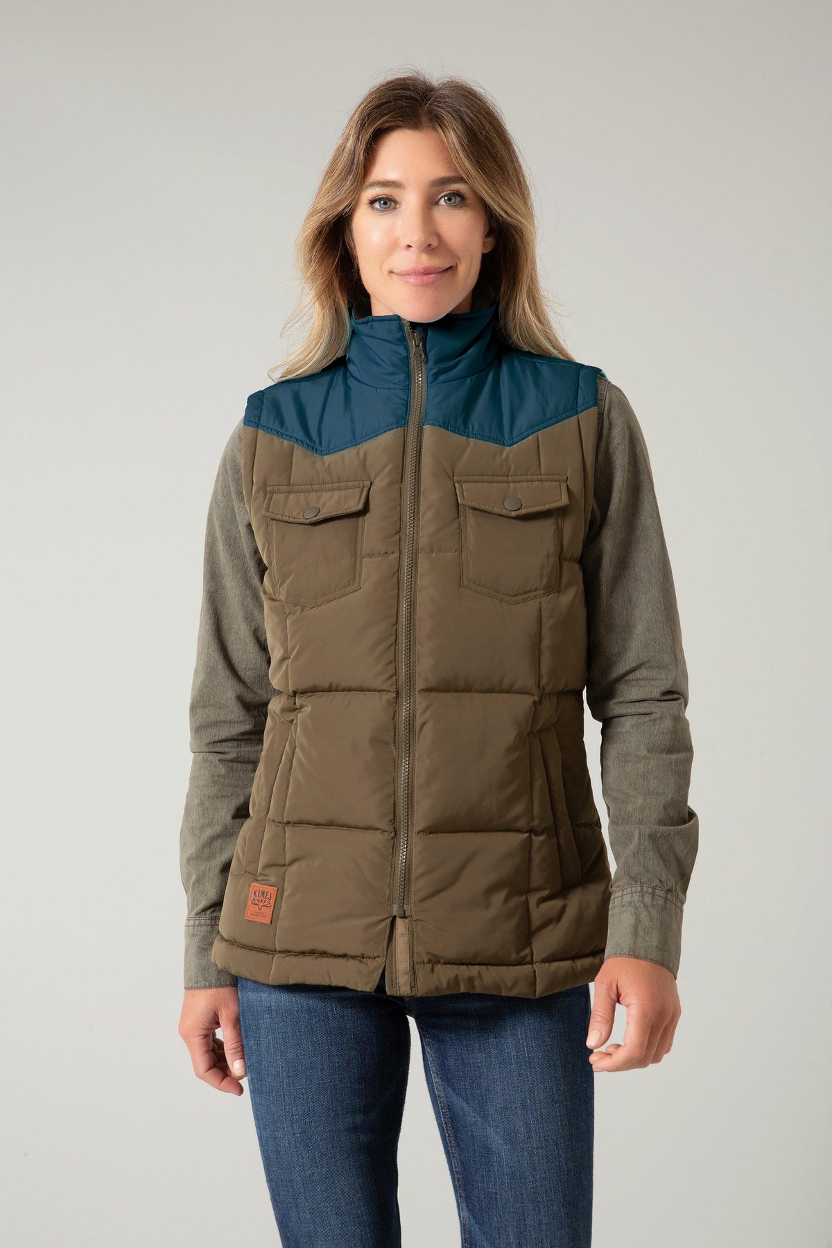 Kimes Ranch Wyldfire Vest in Army with teal yoke, two front pockets, and a front zipper