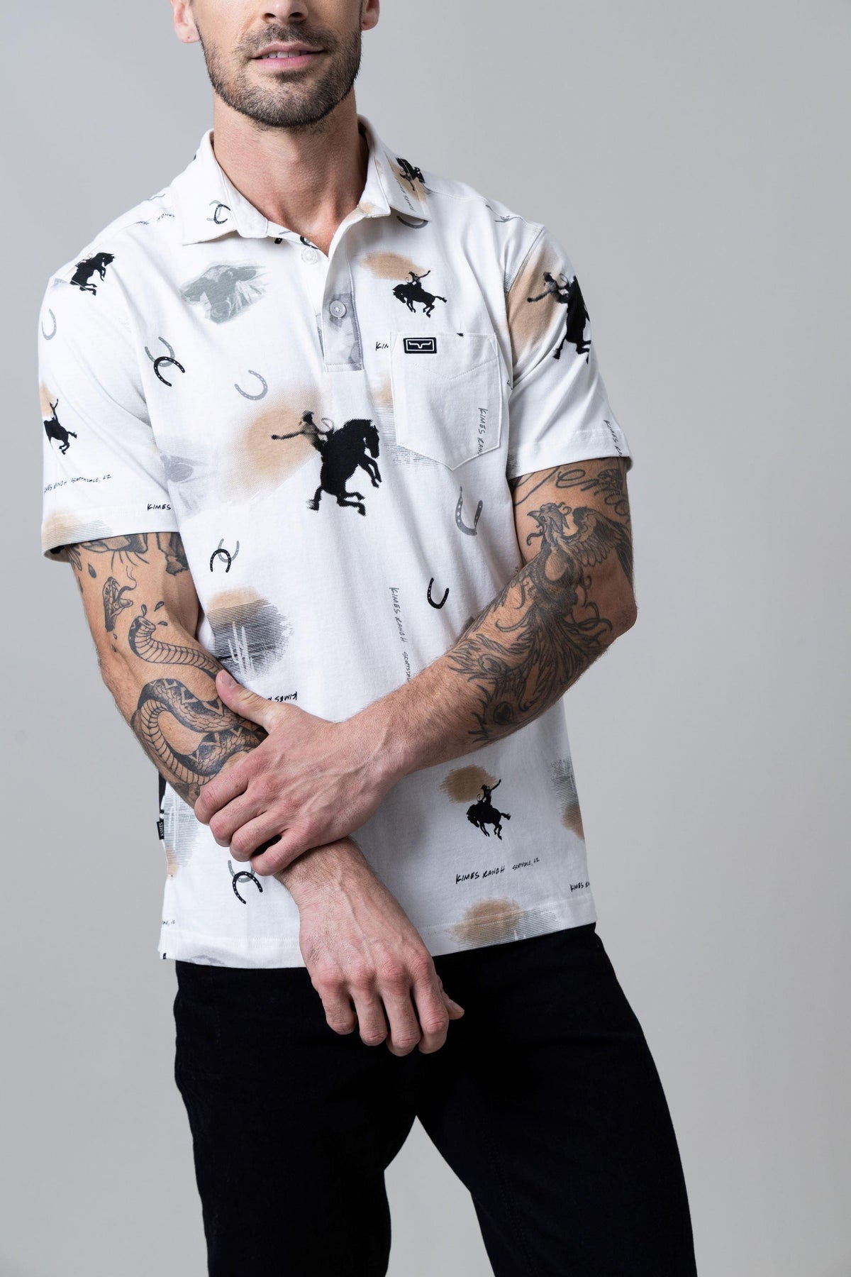 Kimes Ranch Bayard Polo in Light Grey with a graphic print of black bucking horses and horseshoes