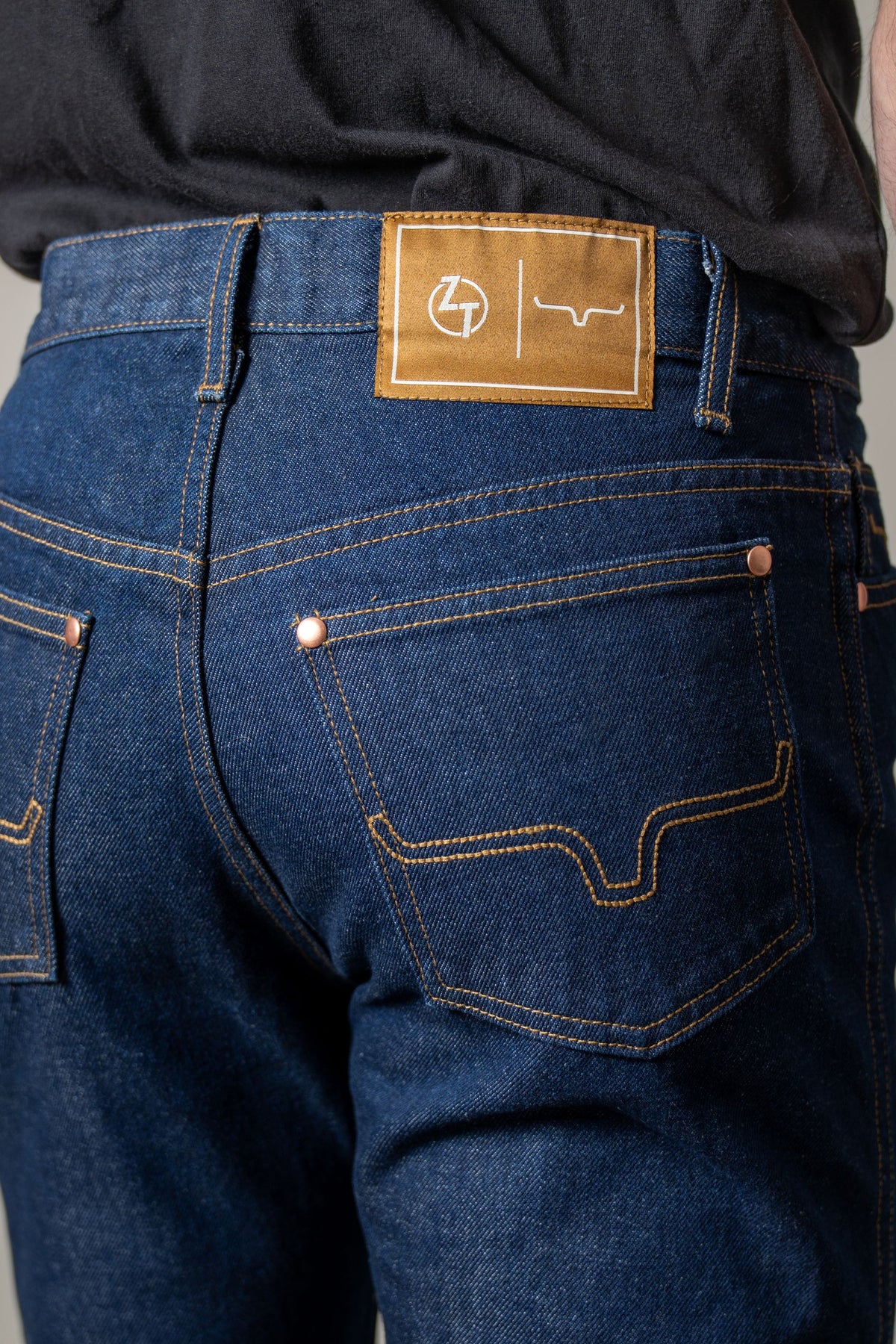 Kimes Ranch ZT, back view, jeans with Dark Wash, copper rivets, and a tan patch with the Kimes Ranch logo
