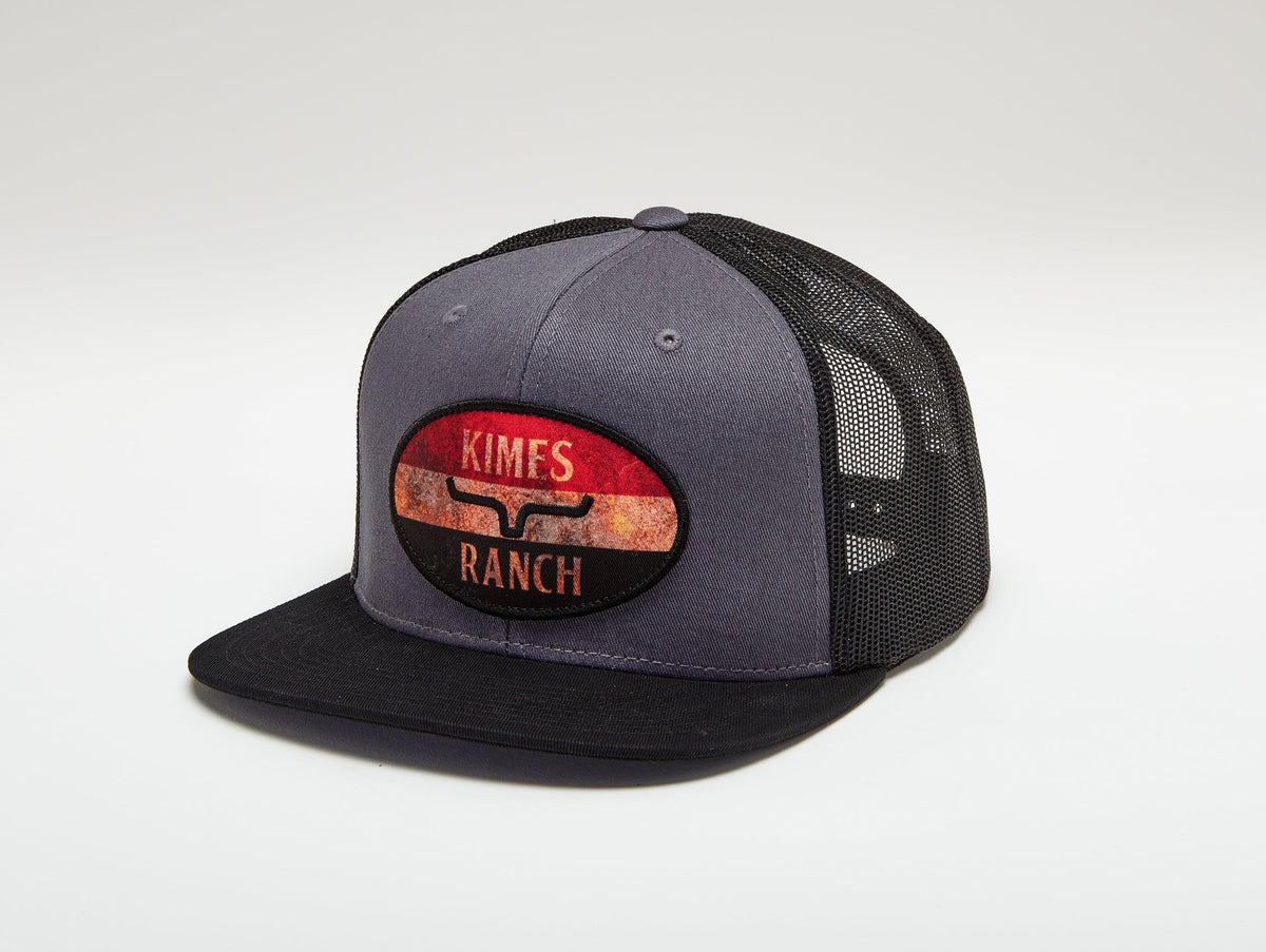 Kimes Ranch American Standard Trucker Hat in Charcoal, side view, with a mesh back and a Kimes Ranch logo patch on the front