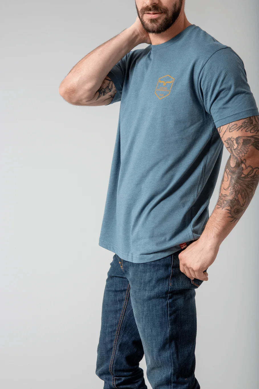 Kimes Ranch Shielded Trucker Shirt, side view, in blue with a chest logo and short sleeves