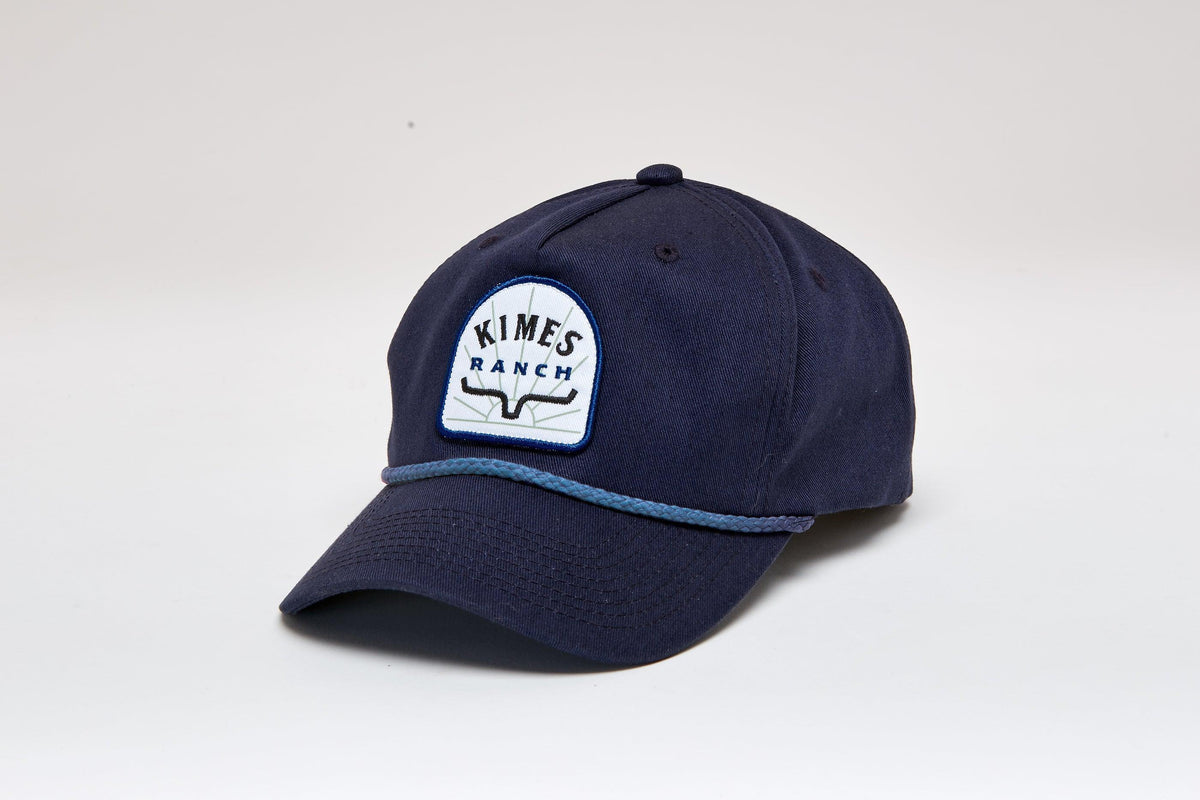 Kimes Ranch Mulligans Hat in Navy with a front embroidered logo and light blue braided trim on the brim