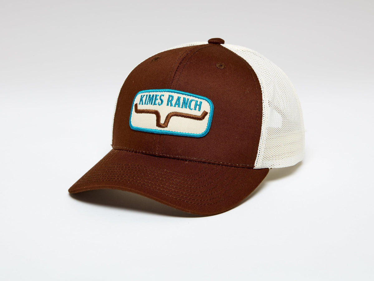 Kimes Ranch Rolling Trucker Hat in Brown with a front embroidered logo patch and cream mesh back