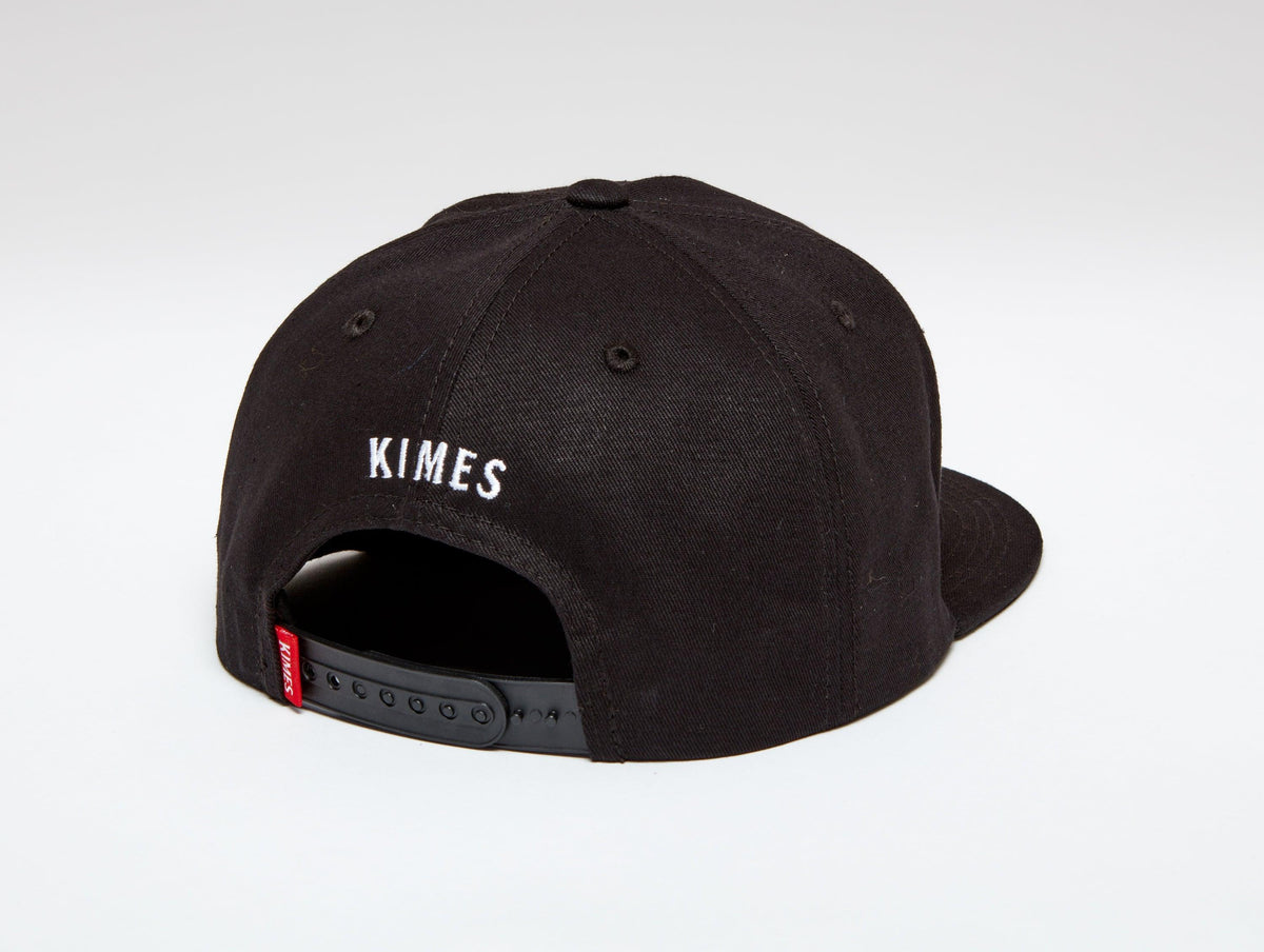 Kimes Ranch Weekly Tall Trucker hat in Black, back view, with KIMES embroidered on the back with a plastic snap closure
