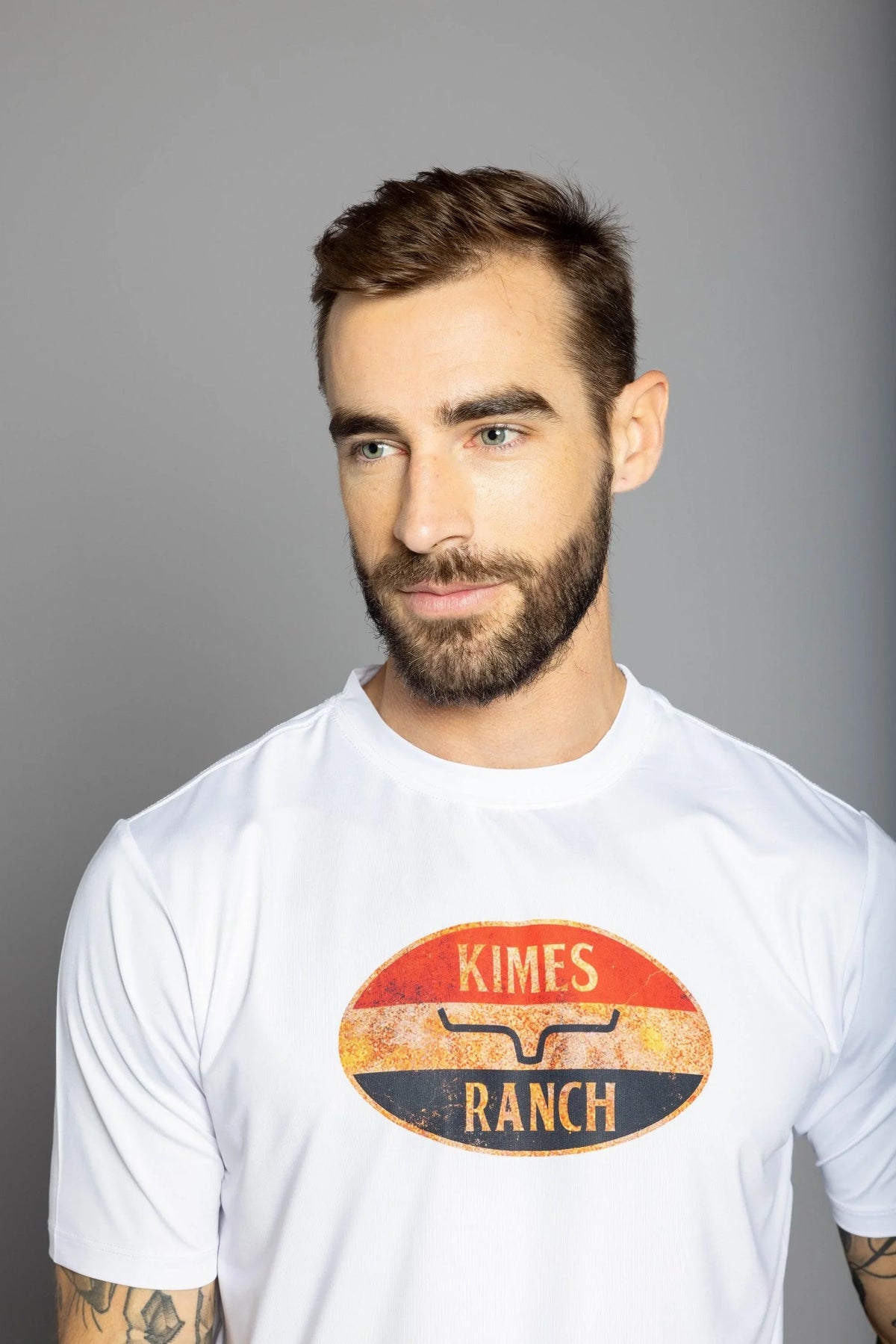 Kimes Ranch American Standard Tech T-Shirt in White with a vintage oval graphic featuring the Kimes Ranch logo and text