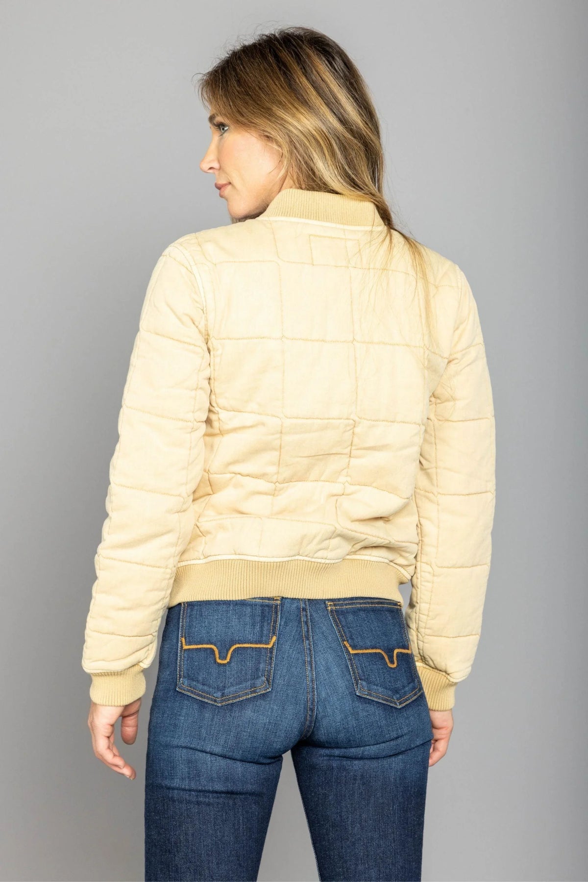 Kimes Ranch Bronc Bomber Jacket in Off White, back view, with a quilted back yoke and ribbed hem