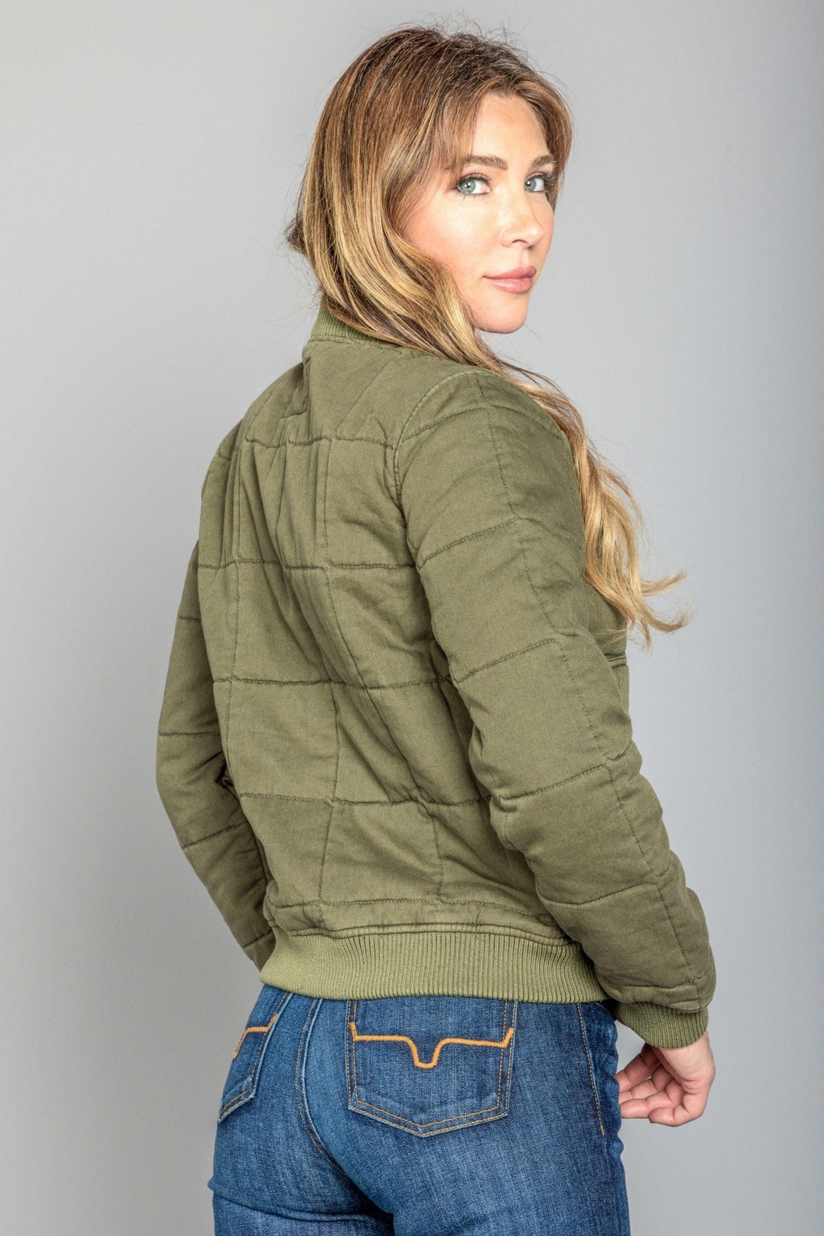 Kimes Ranch Bronc Bomber Jacket in Sage, back view, with quilted back yoke and ribbed hem