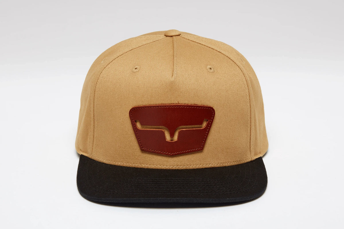 Kimes Ranch Ghost Face Hat in tan with a black brim and a brown logo patch on the front