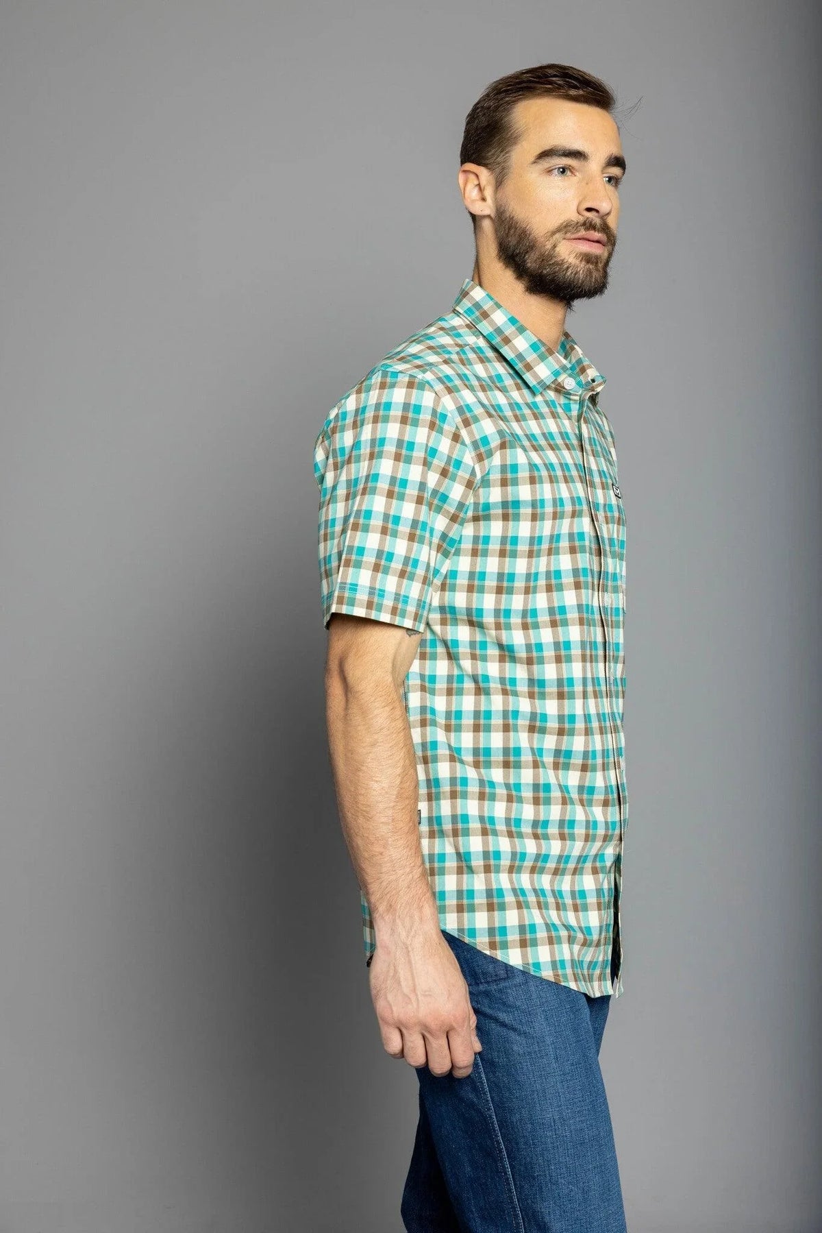 Kimes Ranch Go Round Plaid Dress Shirt in Teal, side view, with brown and white checks and short sleeves
