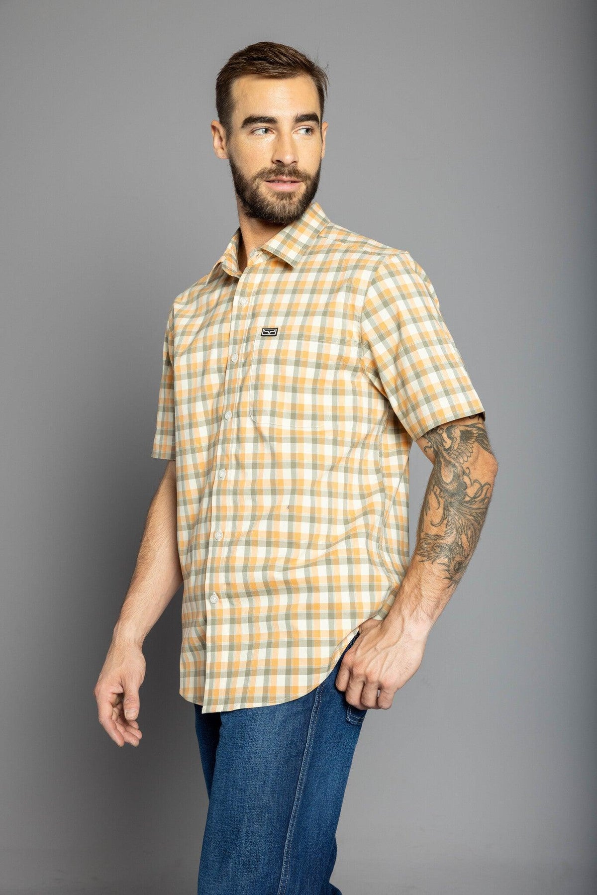 Kimes Ranch Go Round Plaid Dress Shirt in Gold, side view, with short sleeves and a chest pocket