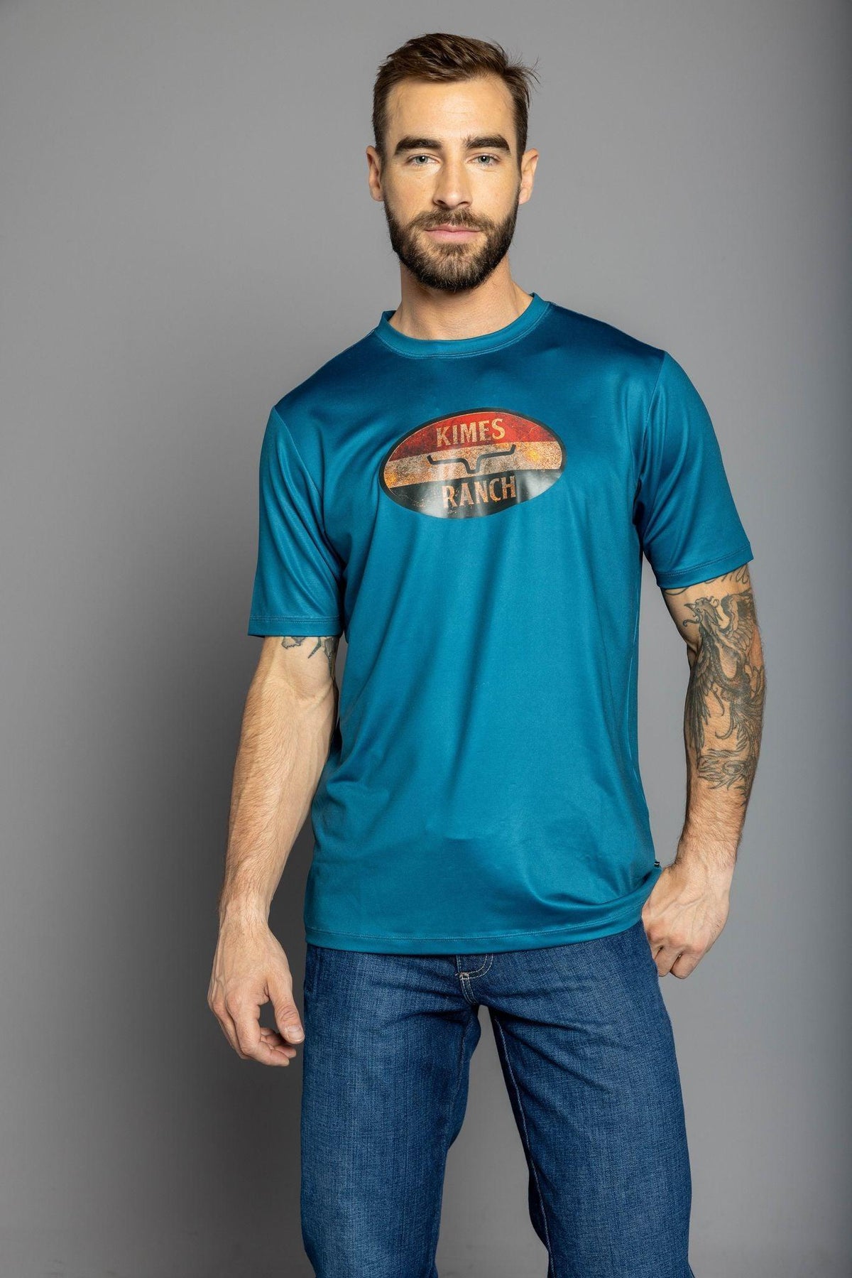 Kimes Ranch American Standard Tech T-Shirt in Dark Blue with a vintage oval Kimes Ranch logo on the chest