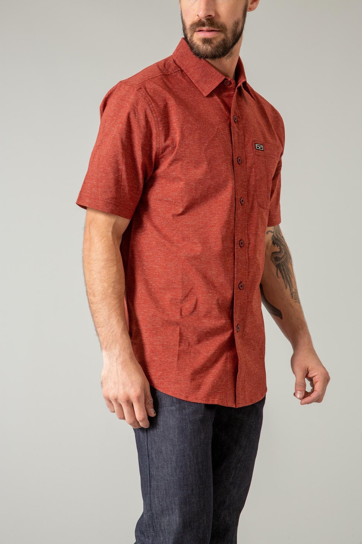 Kimes Ranch Linville Short Sleeve Dress Shirt in Dark Red, side view, with a chest pocket and logo